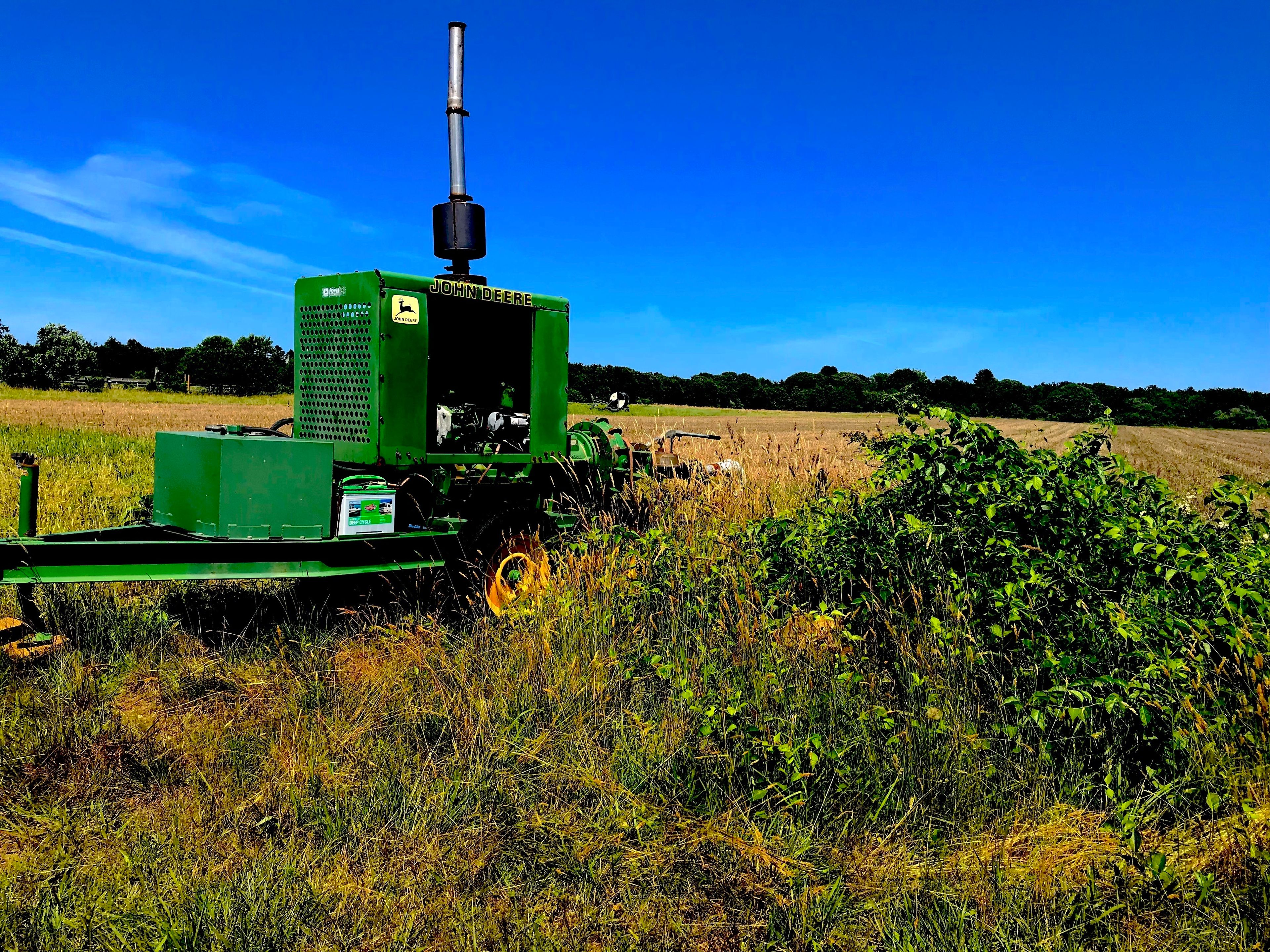 John Deer next to a field that you pass on the right of the grassy trail.