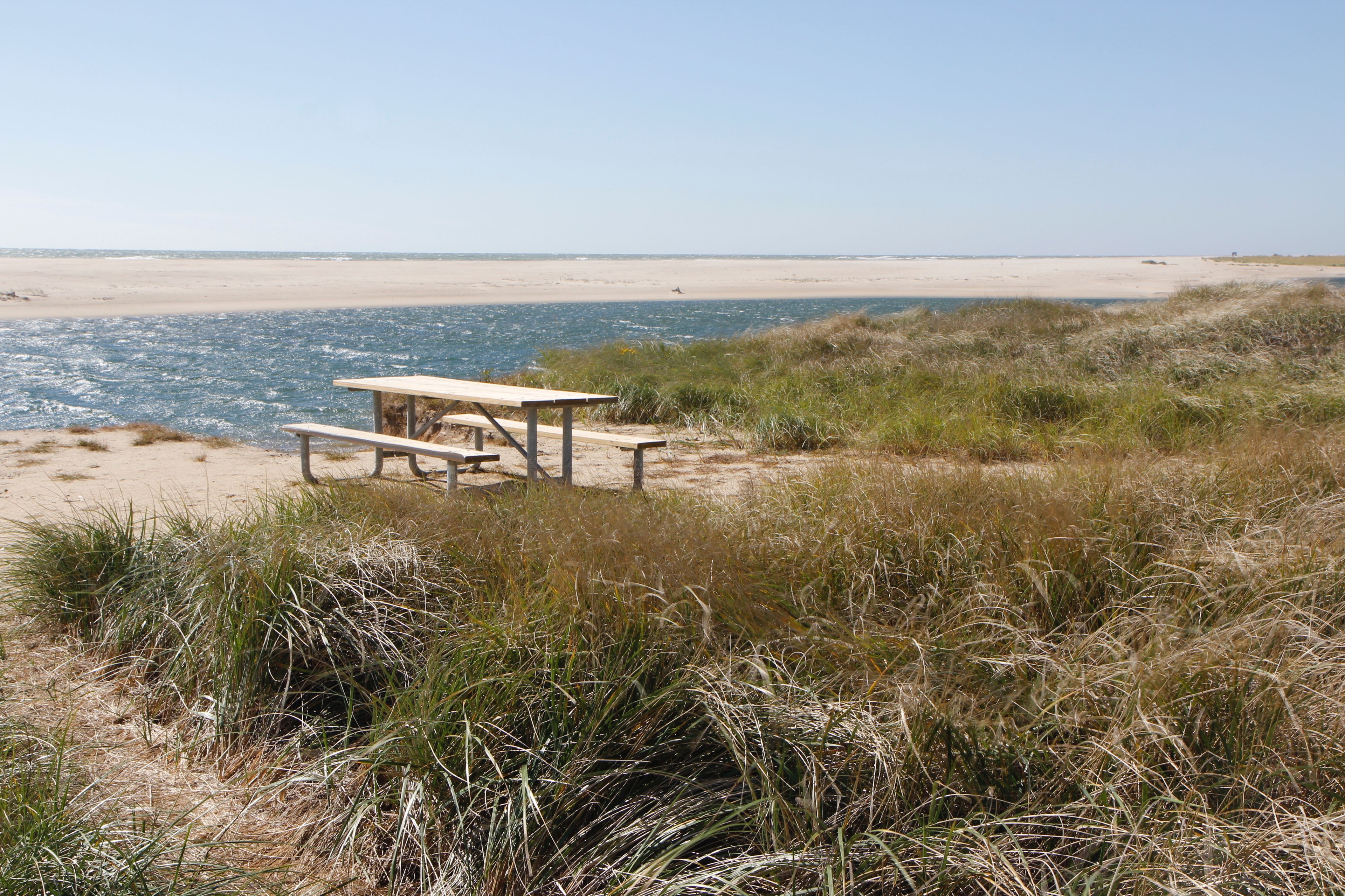 picnic table by water at parking area