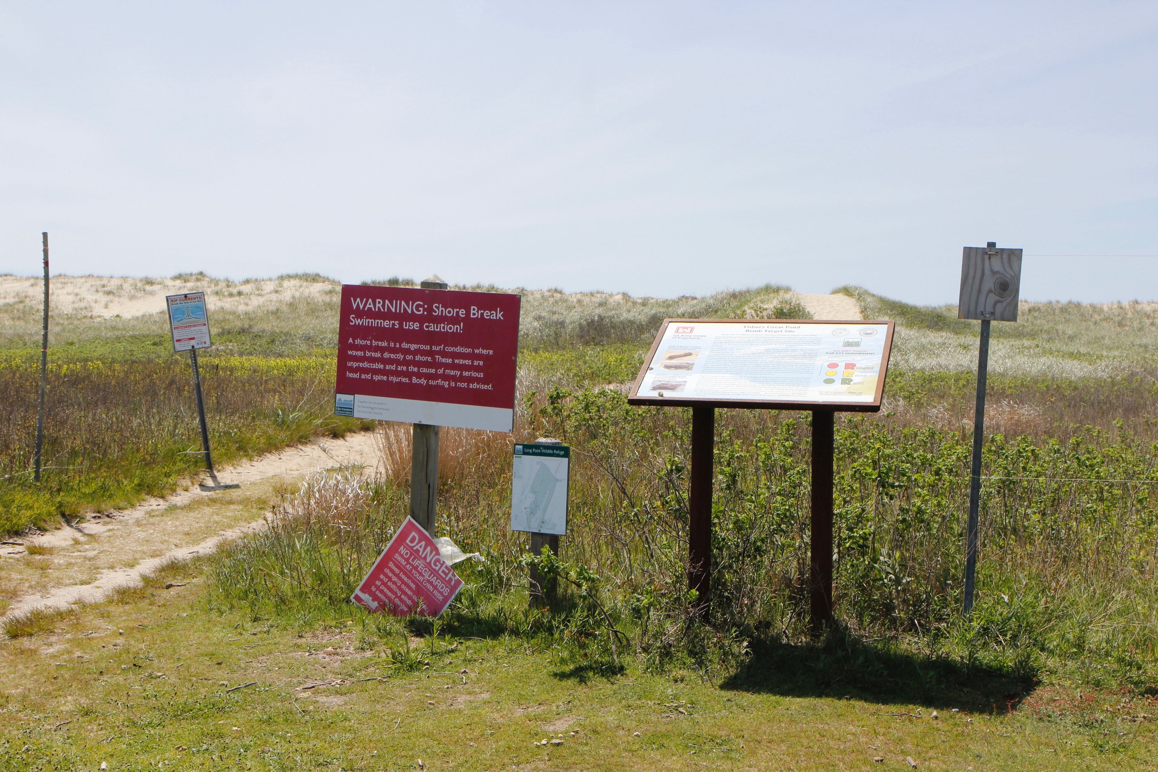 signs by trail to beach