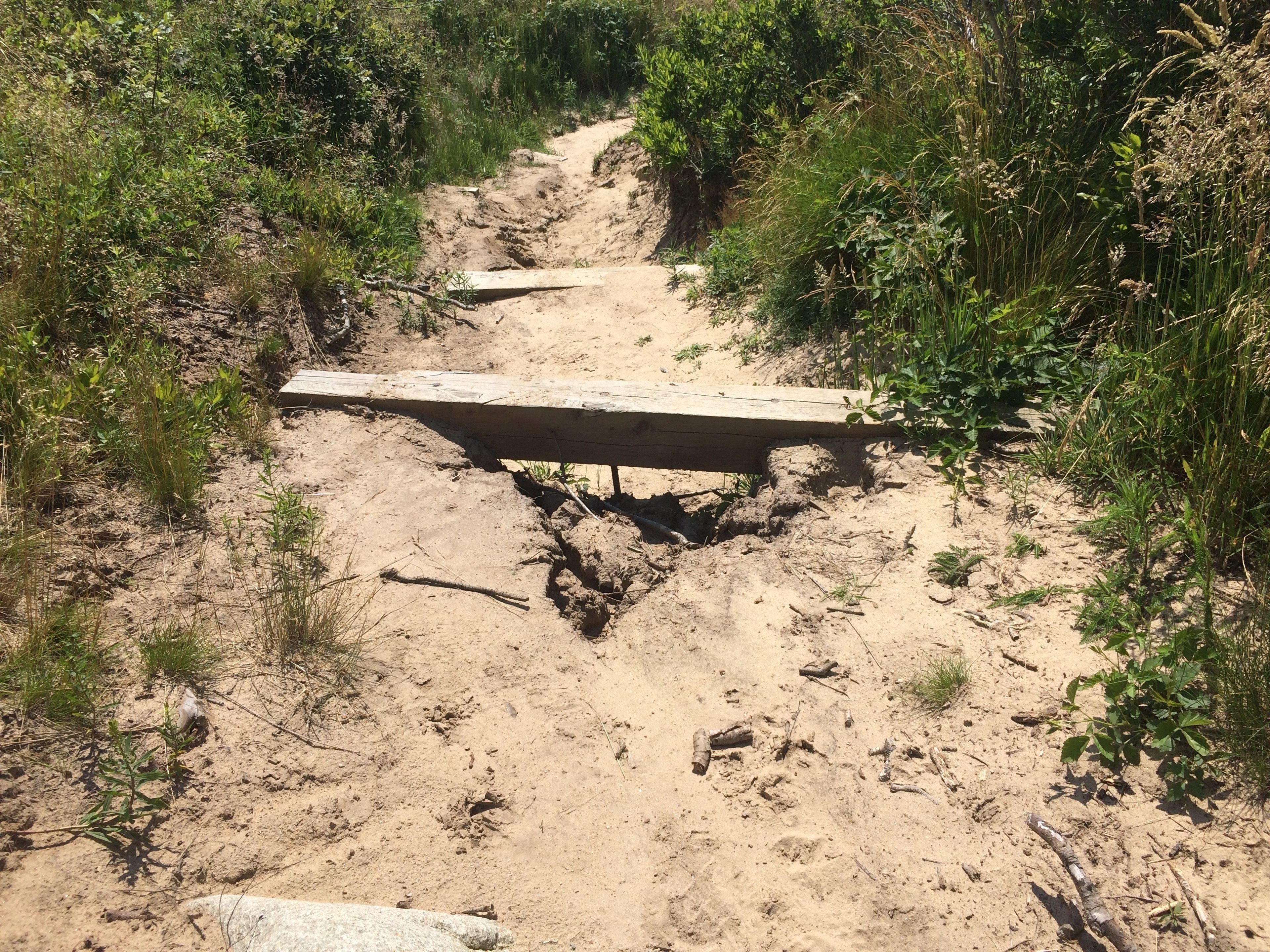 steps and sand and erosion on western path to beach