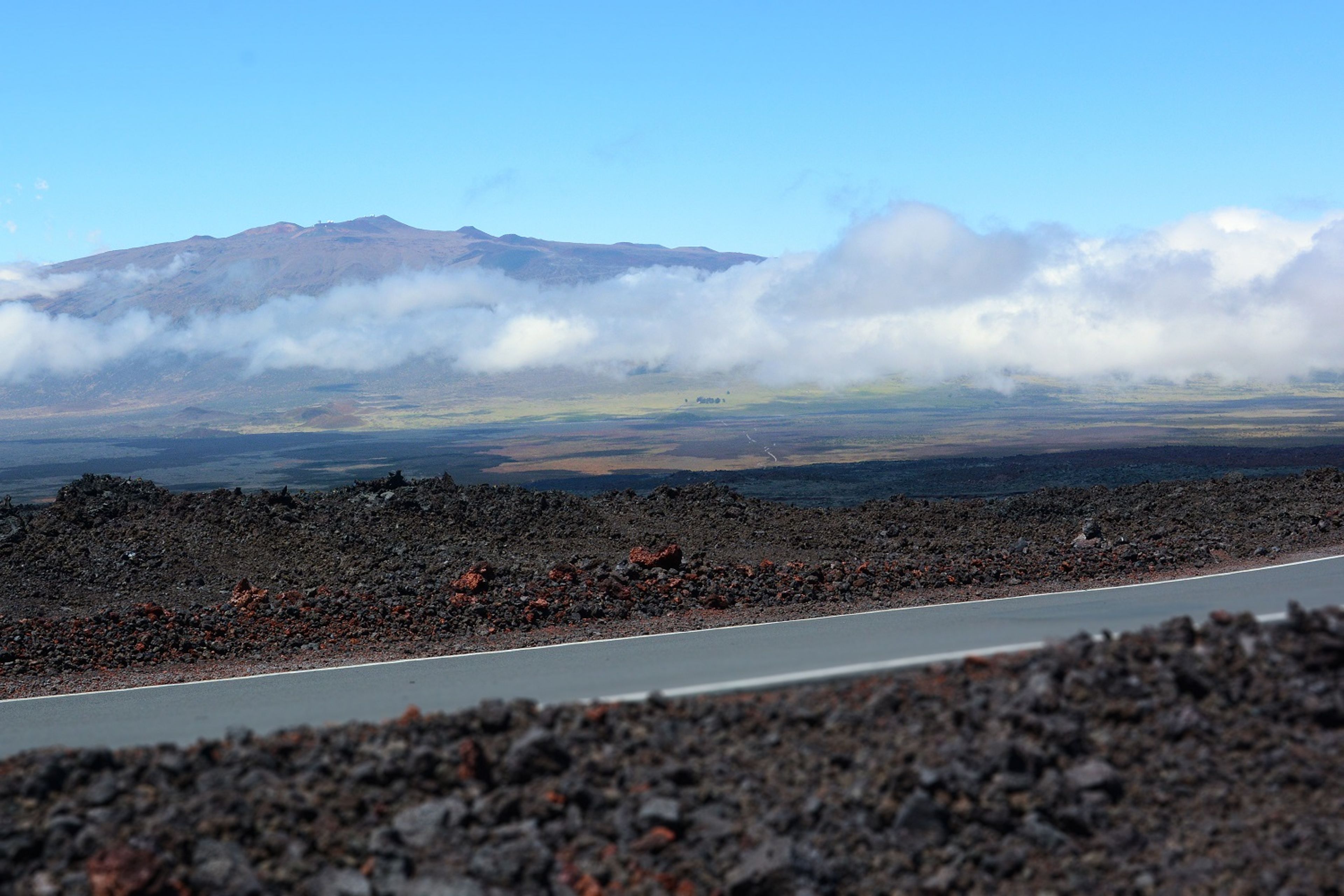 The road offers spectacular views of Mauna Kea and the saddle in-between.