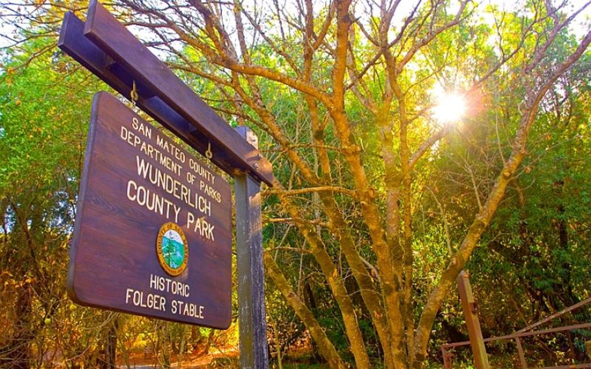 The entrance sign as seen from Highway 84 (Woodside Road).