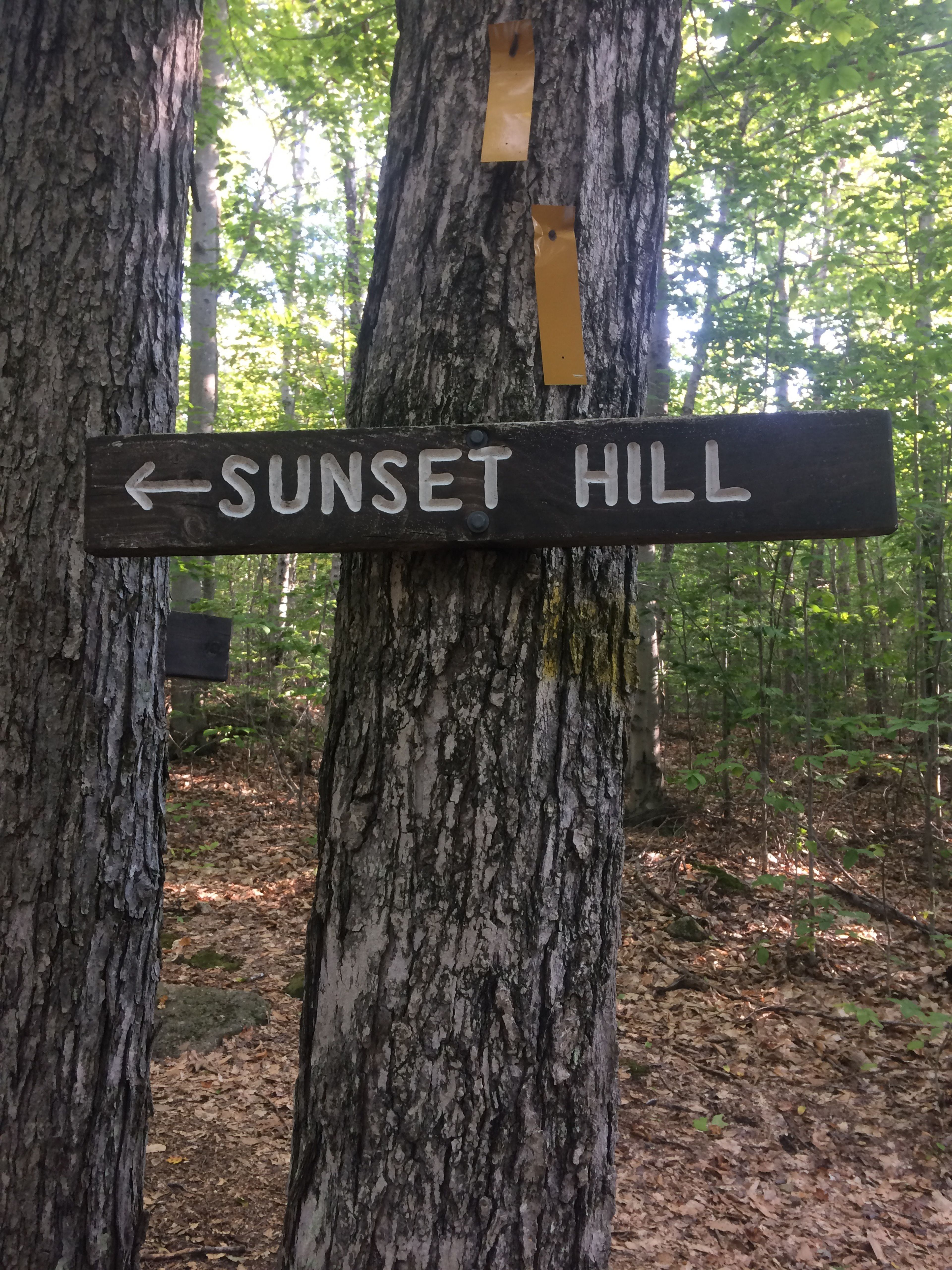 A sign points to Sunset Hill.