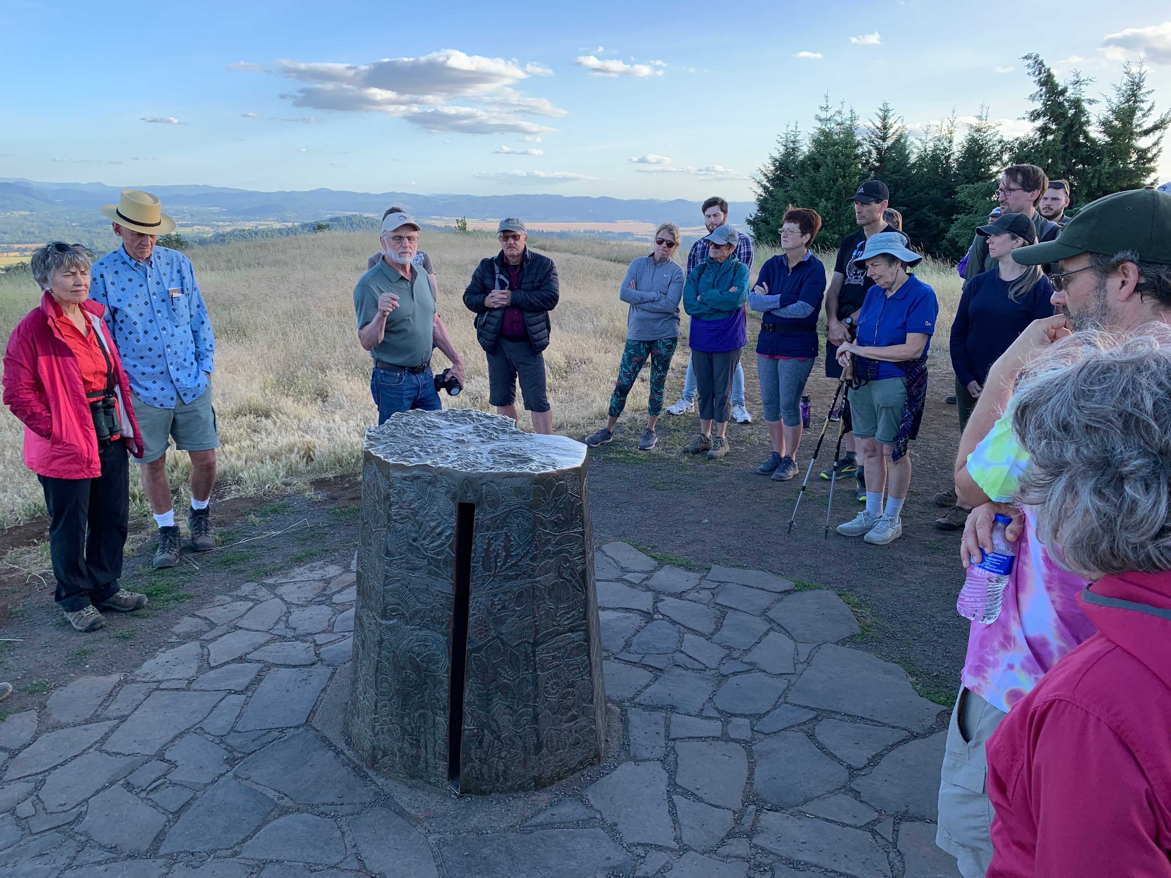 Pete Helzer, the Sculptor of the Monument, Explaining it to Visitors