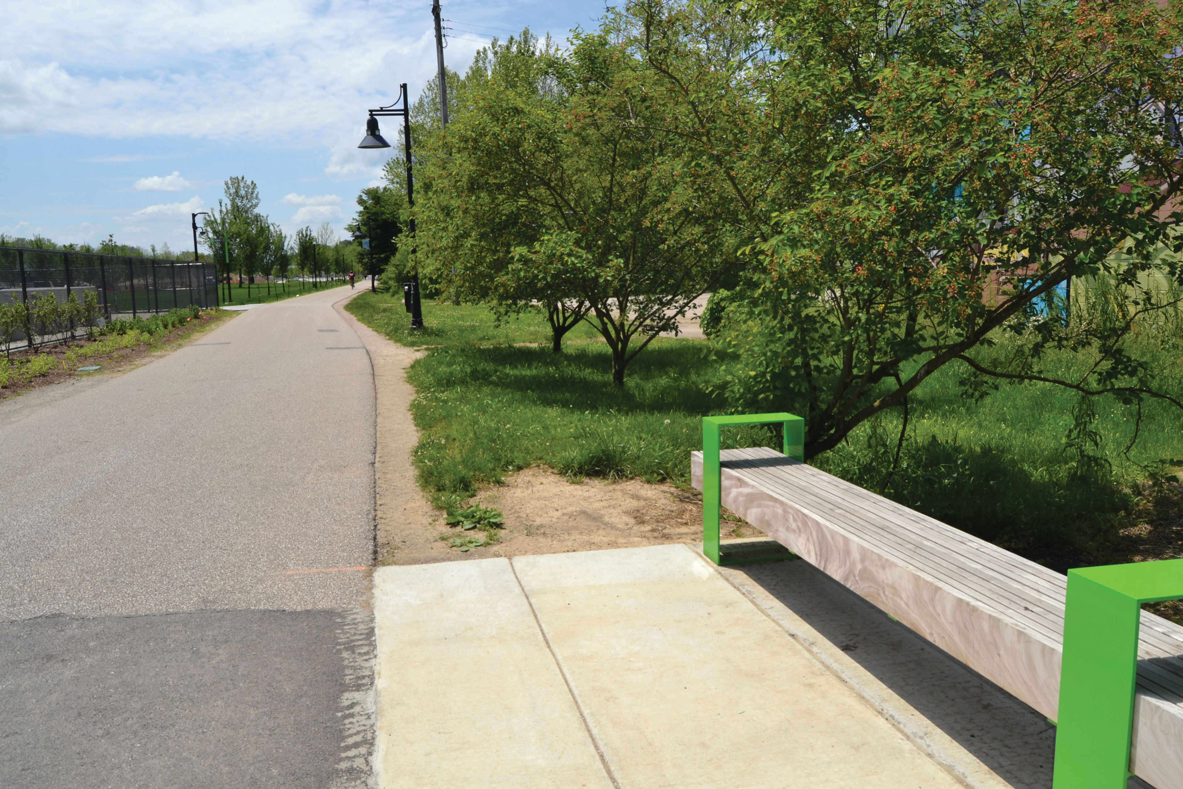 A bench offers a place to rest on the B-Line Trail in Switchyard Park.