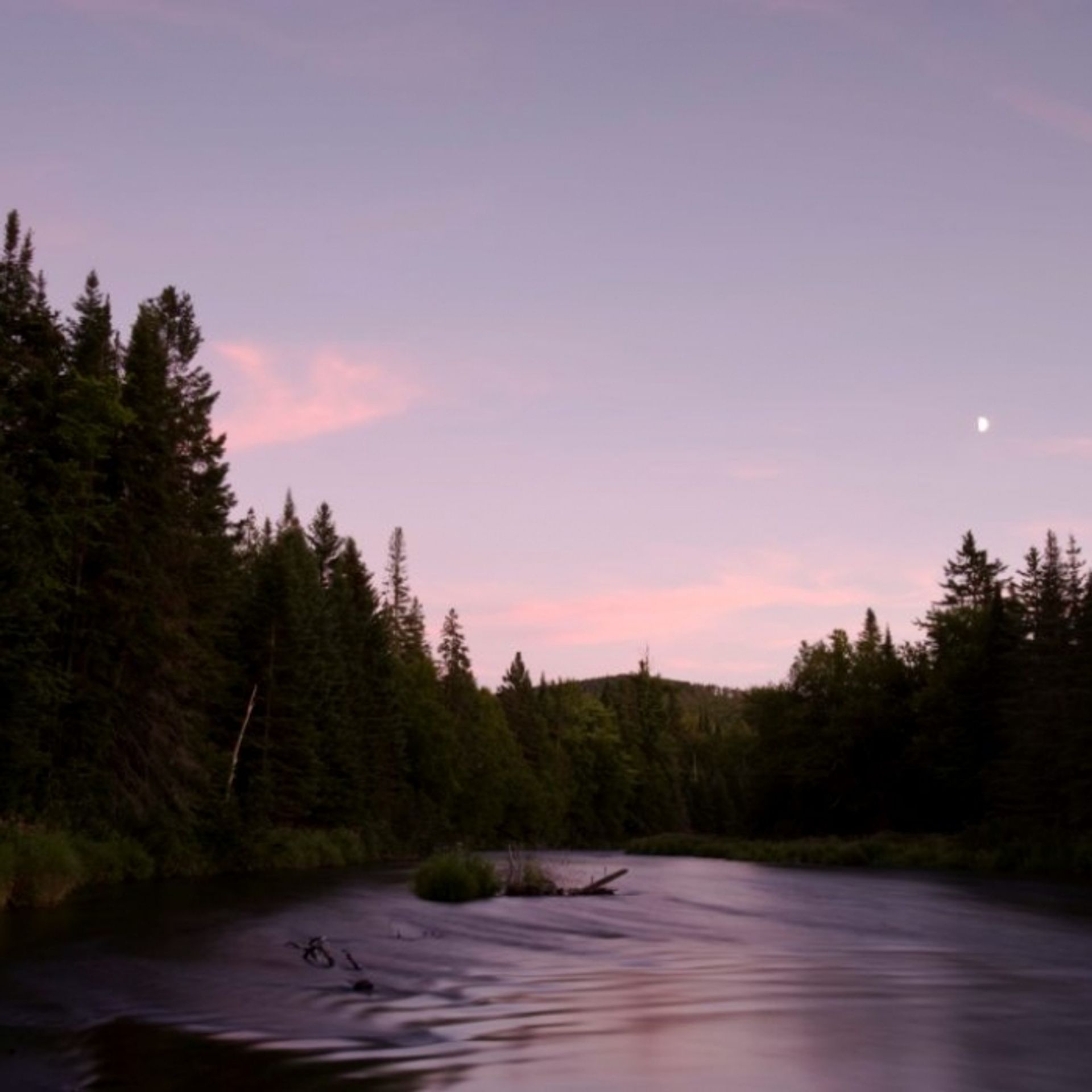 Sunset and the moon rising over the river.