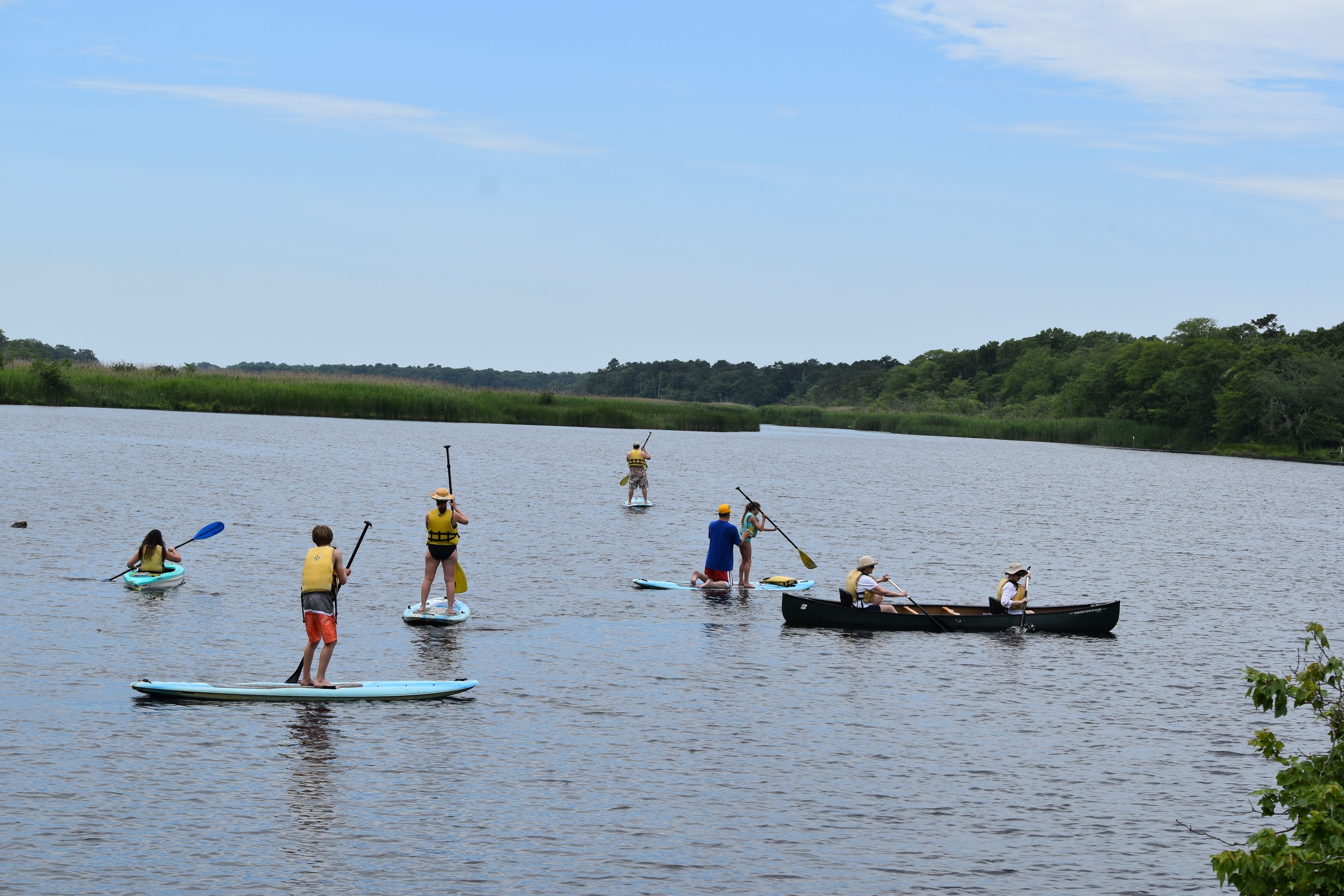 A variety of paddlers enjoy a sunny day on the Carmans river.