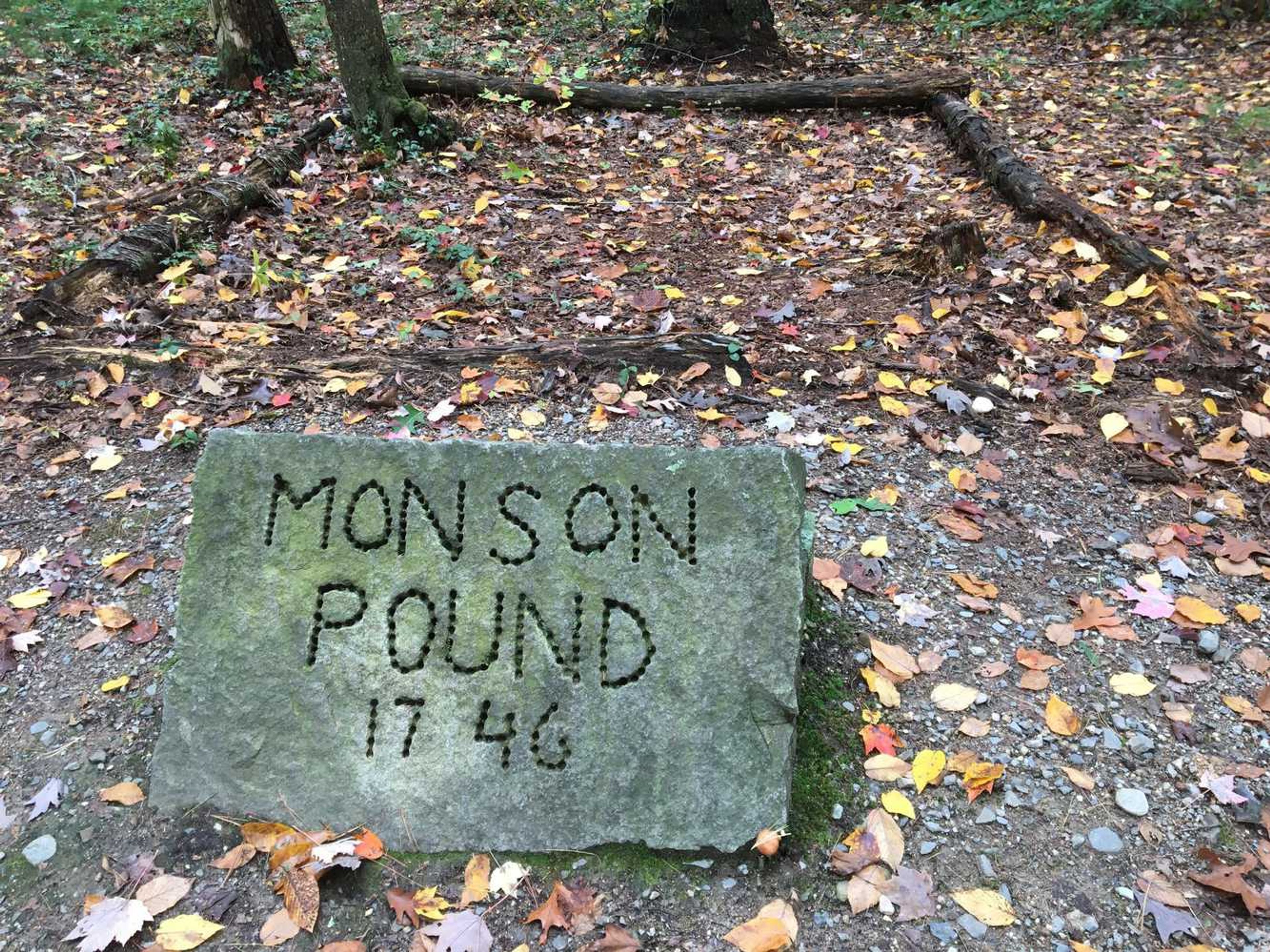 Letters carved into a rock say "Monson Pound 1746."