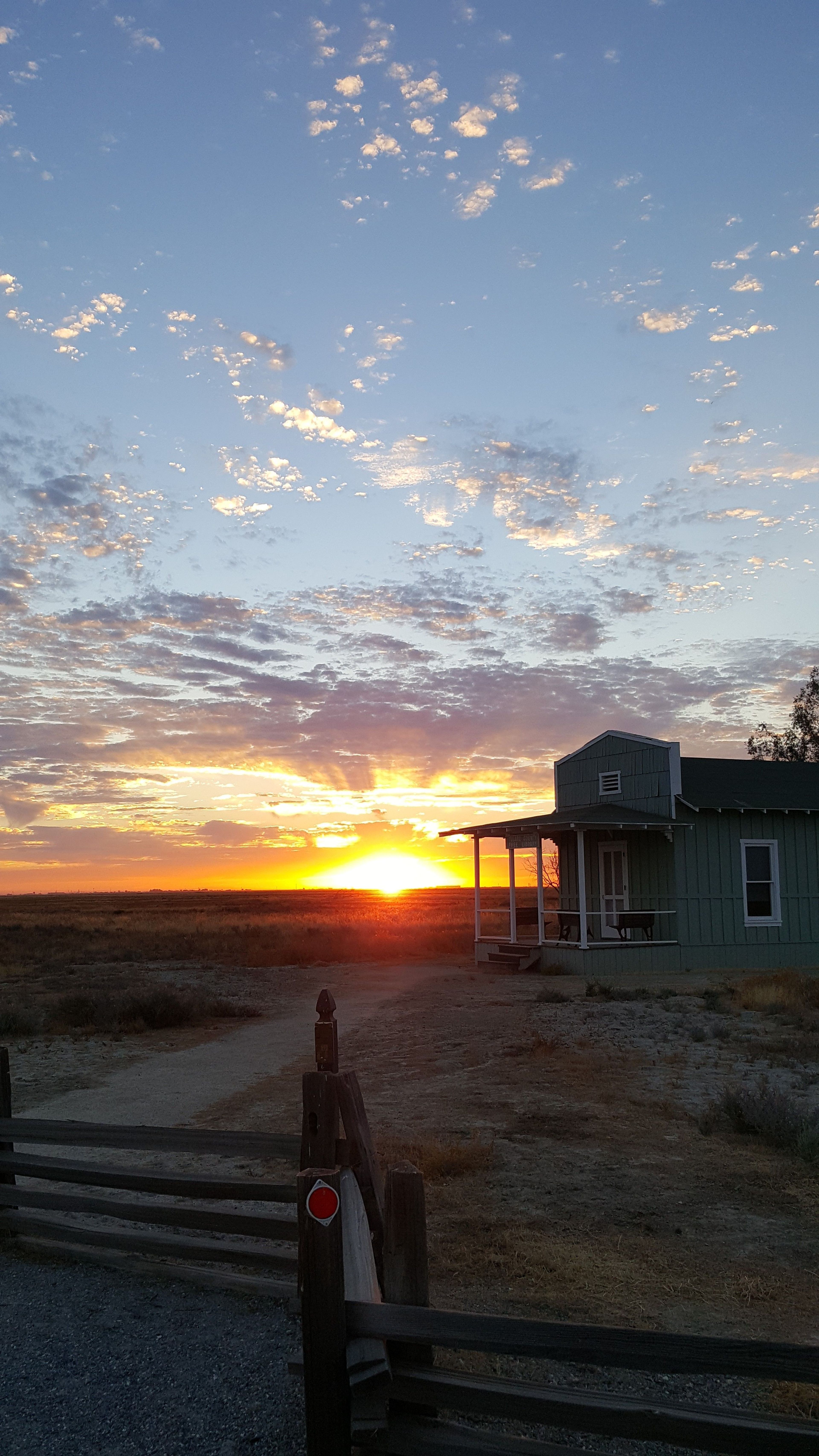 A vivid summer sunset showing the Mary Dickerson Library at Colonel Allensworth SHP 