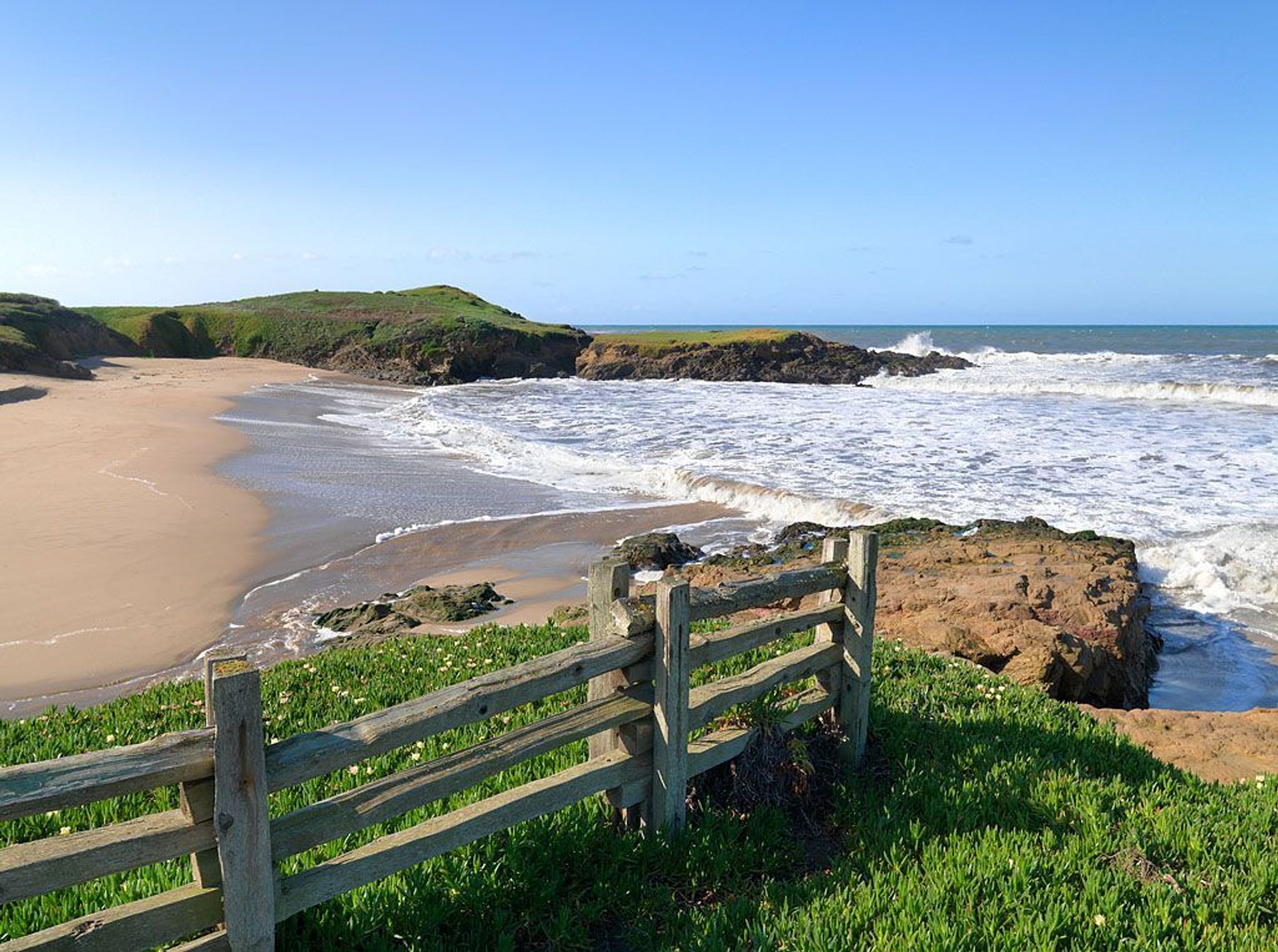 Coastal view with wooden fence.