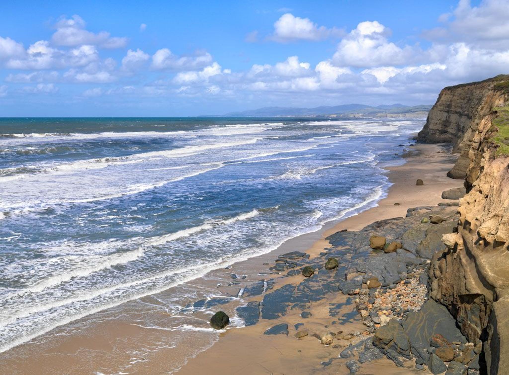 Rocky cliff above the beach at Pescadero.