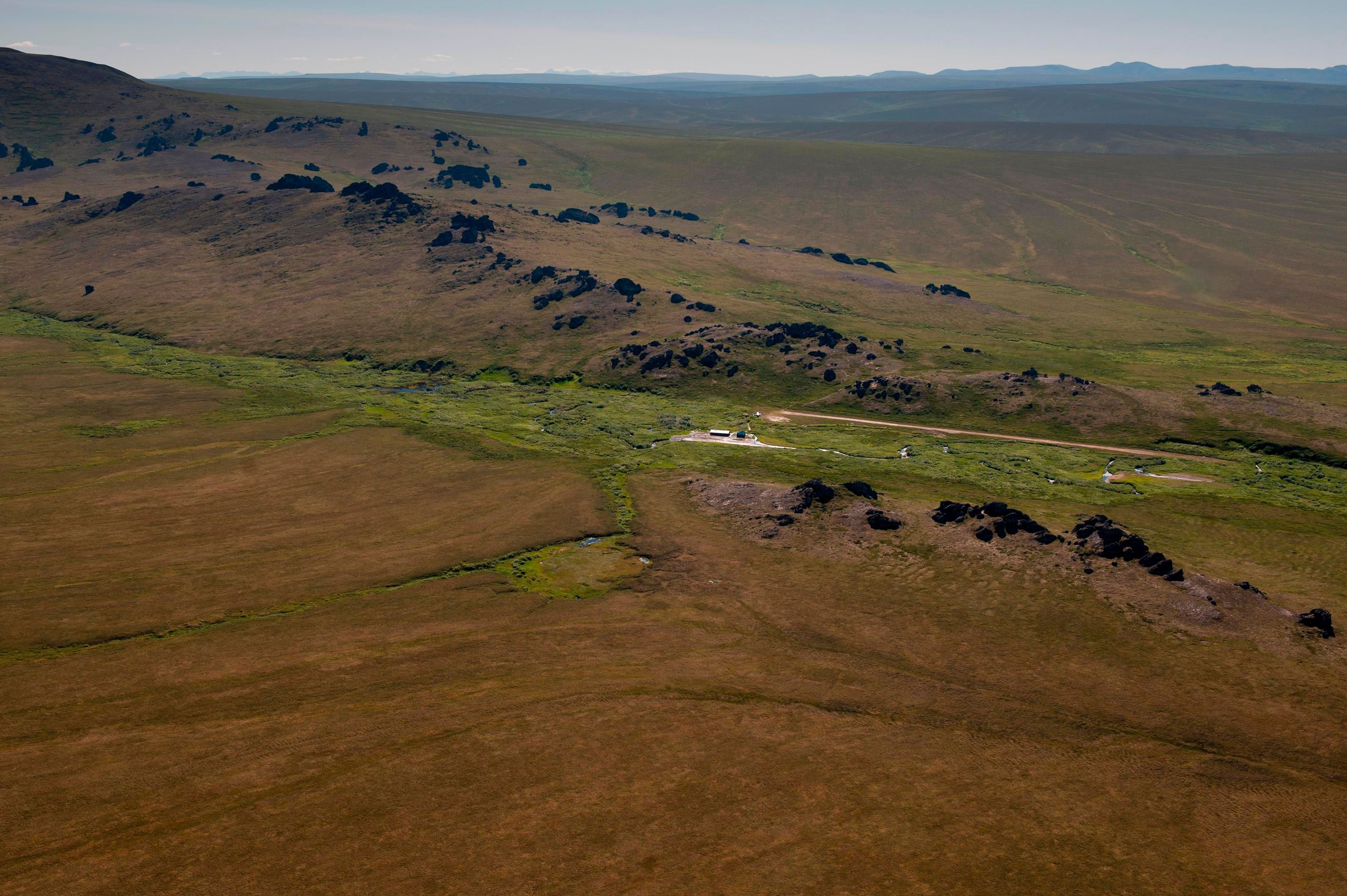 A small aircraft descends on Serpentine Hot Springs.