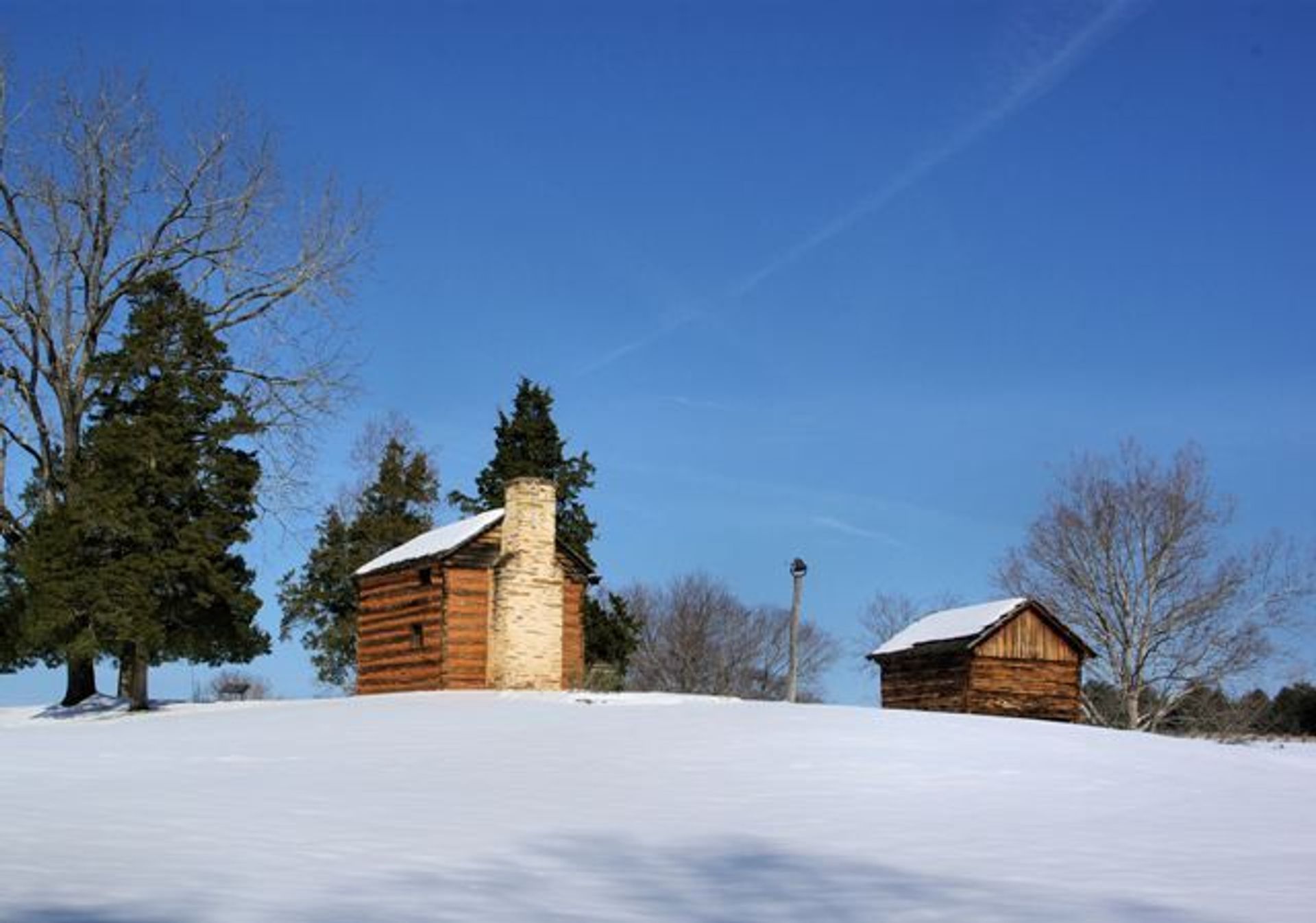 The reconstructed kitchen cabin and smoke house on the farm where Booker T. Washington was born.