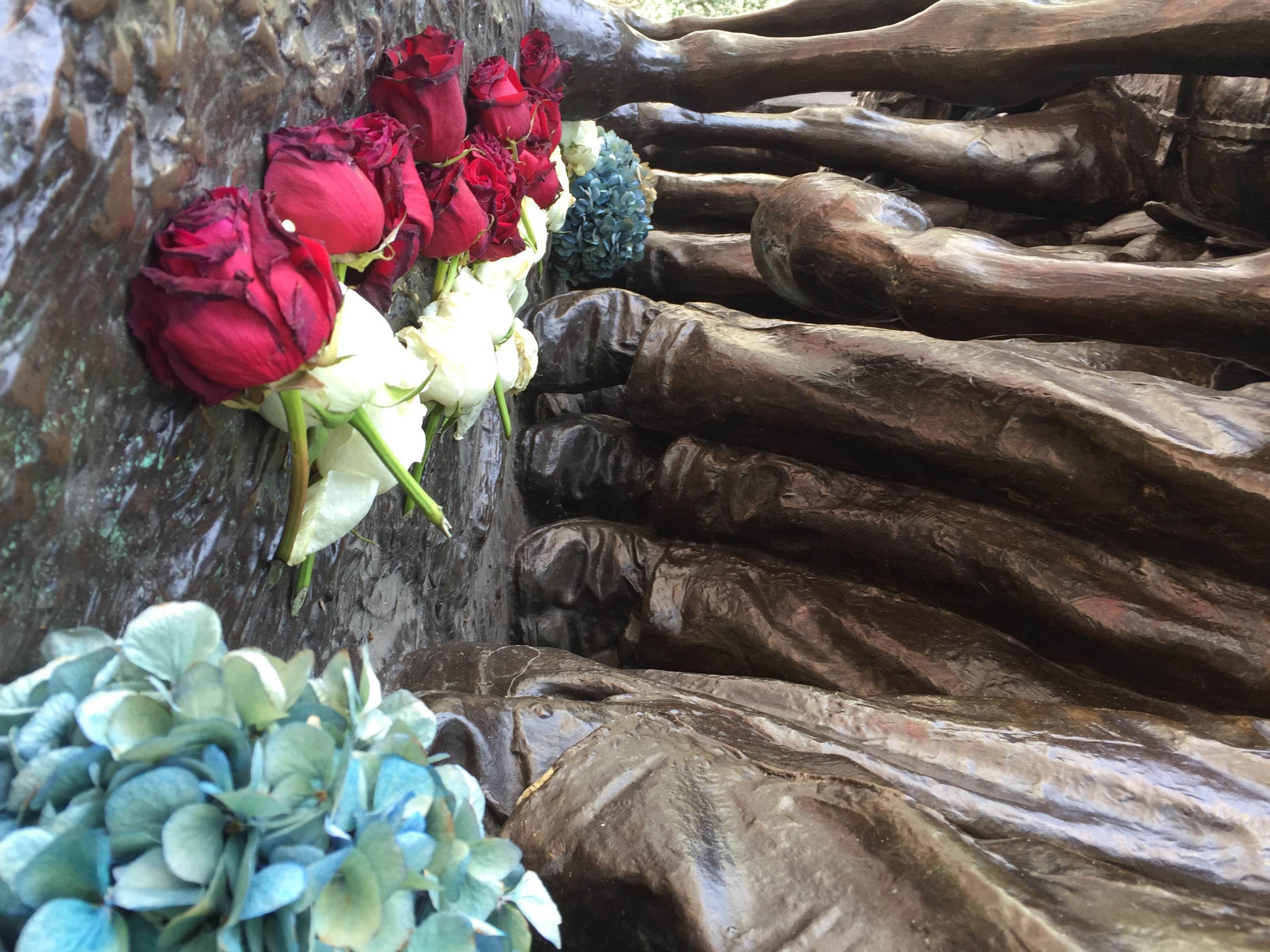 Flowers laid at the feet of the soldiers on the Robert Gould Shaw Memorial.