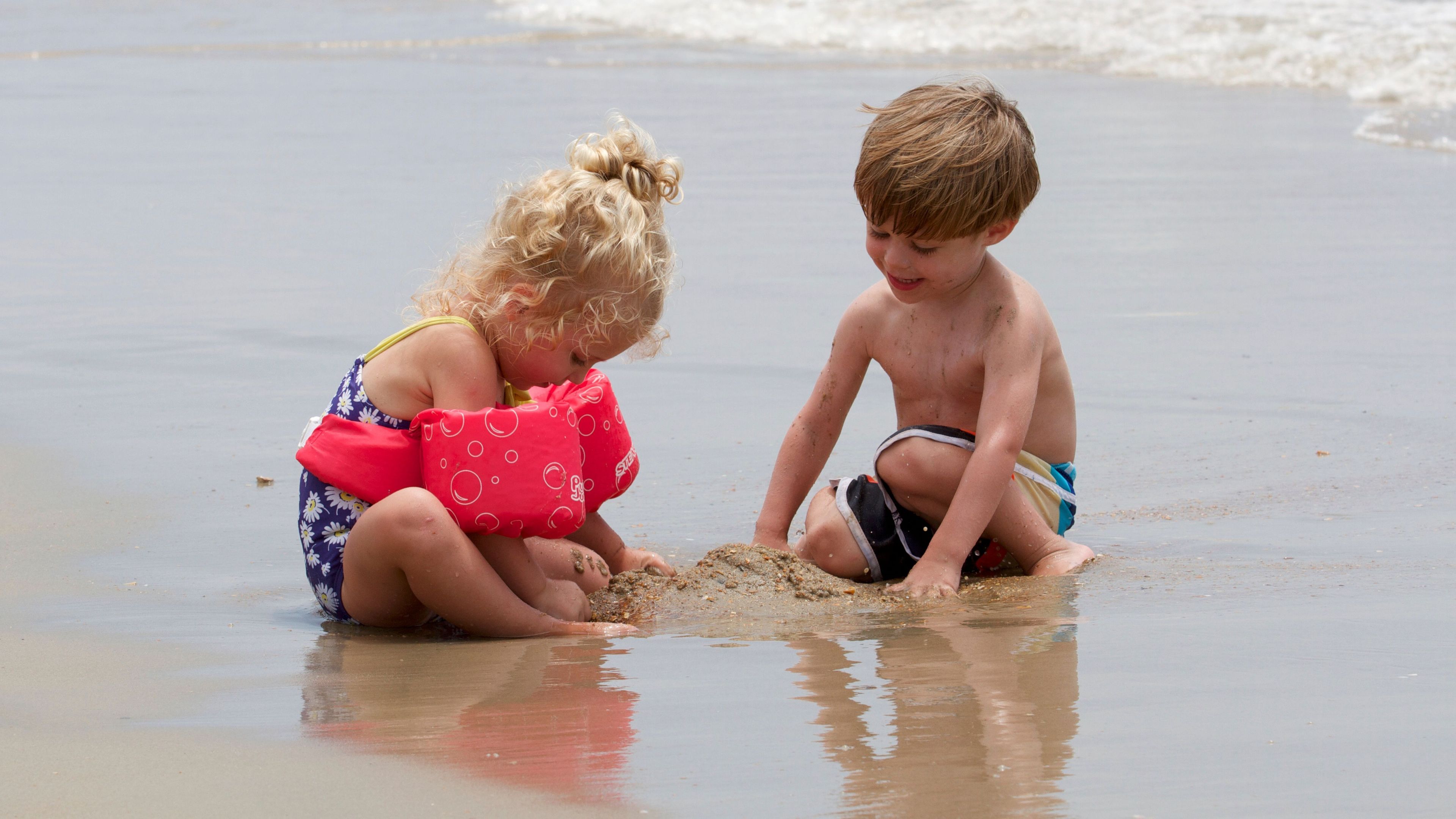 Two kids enjoy the sands of Cape Hatteras.