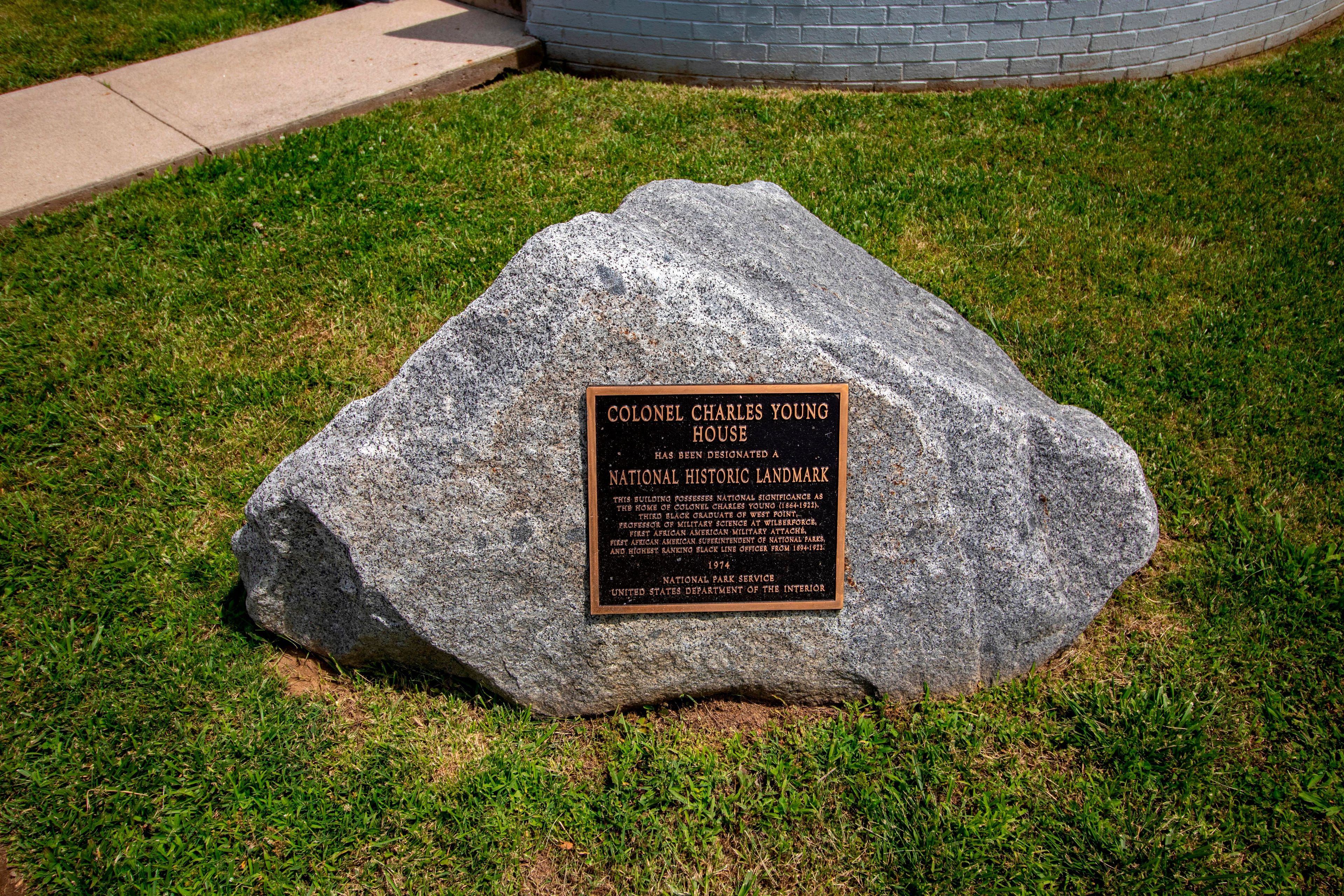 The large stone boulder with Historic Plaque affixed to it, sits in the front yard of Youngsholm