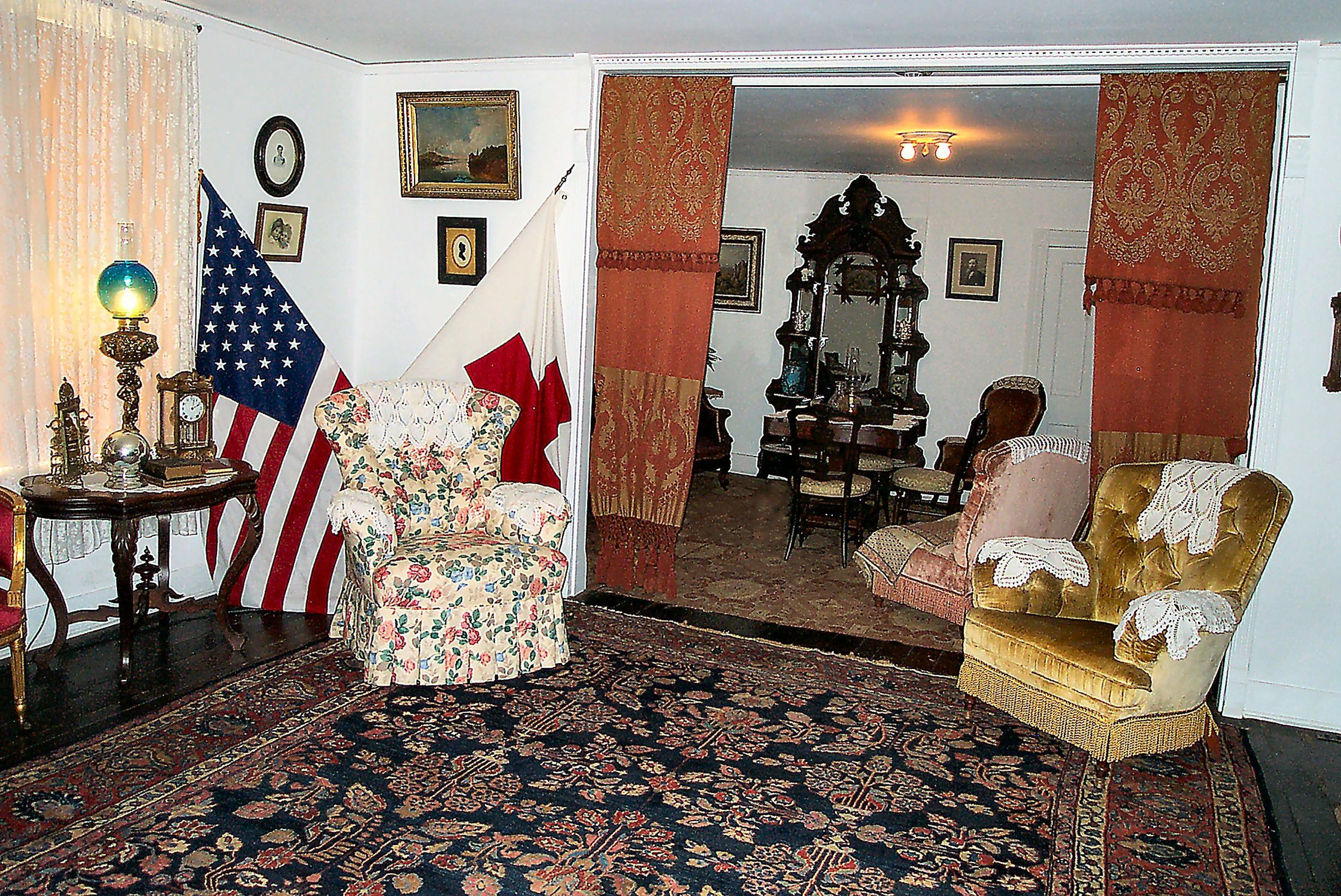 Front Parlor, Clara Barton's favorite chair in front of flags.