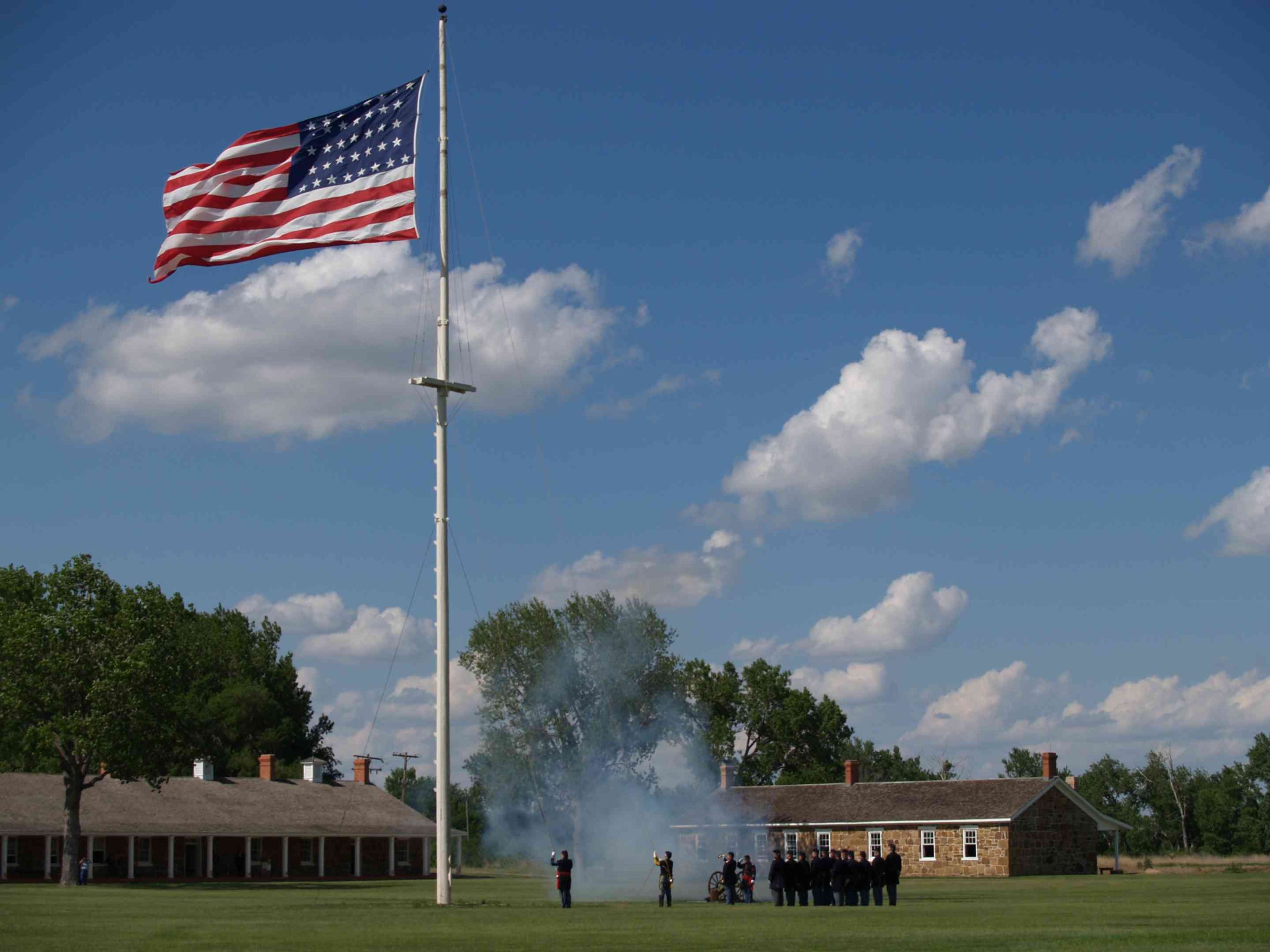 Volunteers help recreate the U.S. Army flag lowering ceremony known as Retreat.