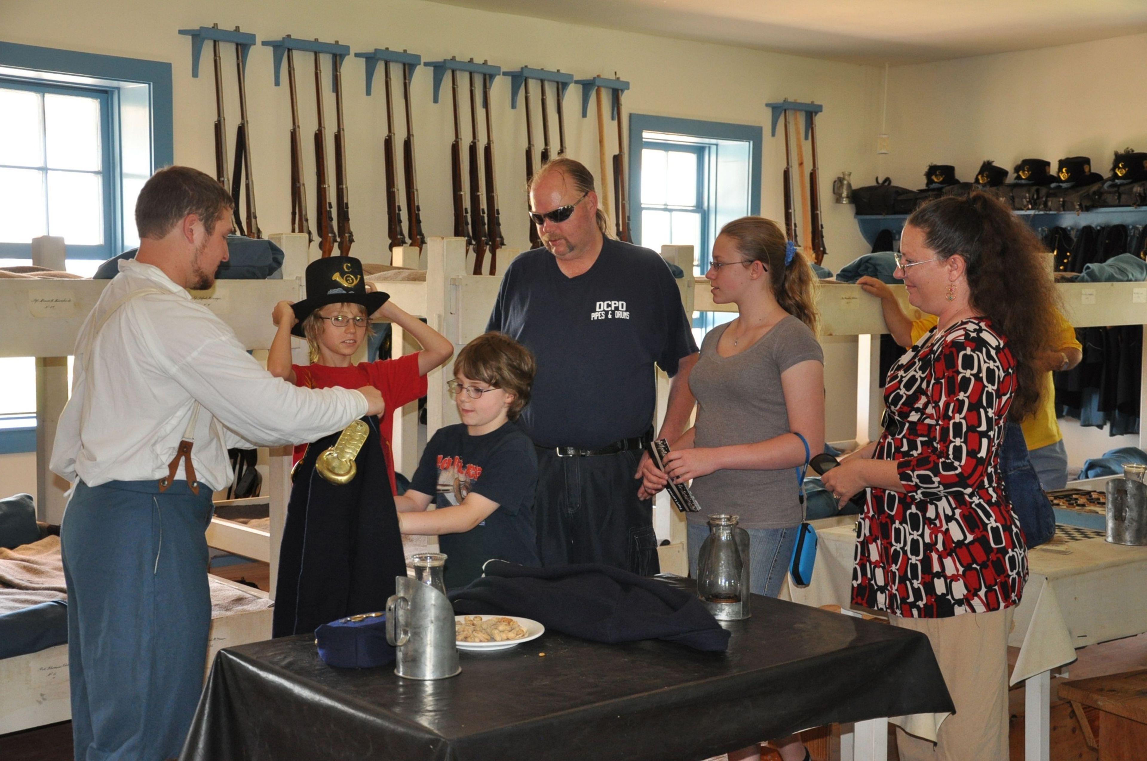 A volunteer shows visitors how soldiers lived during the 1860s at Fort Larned.