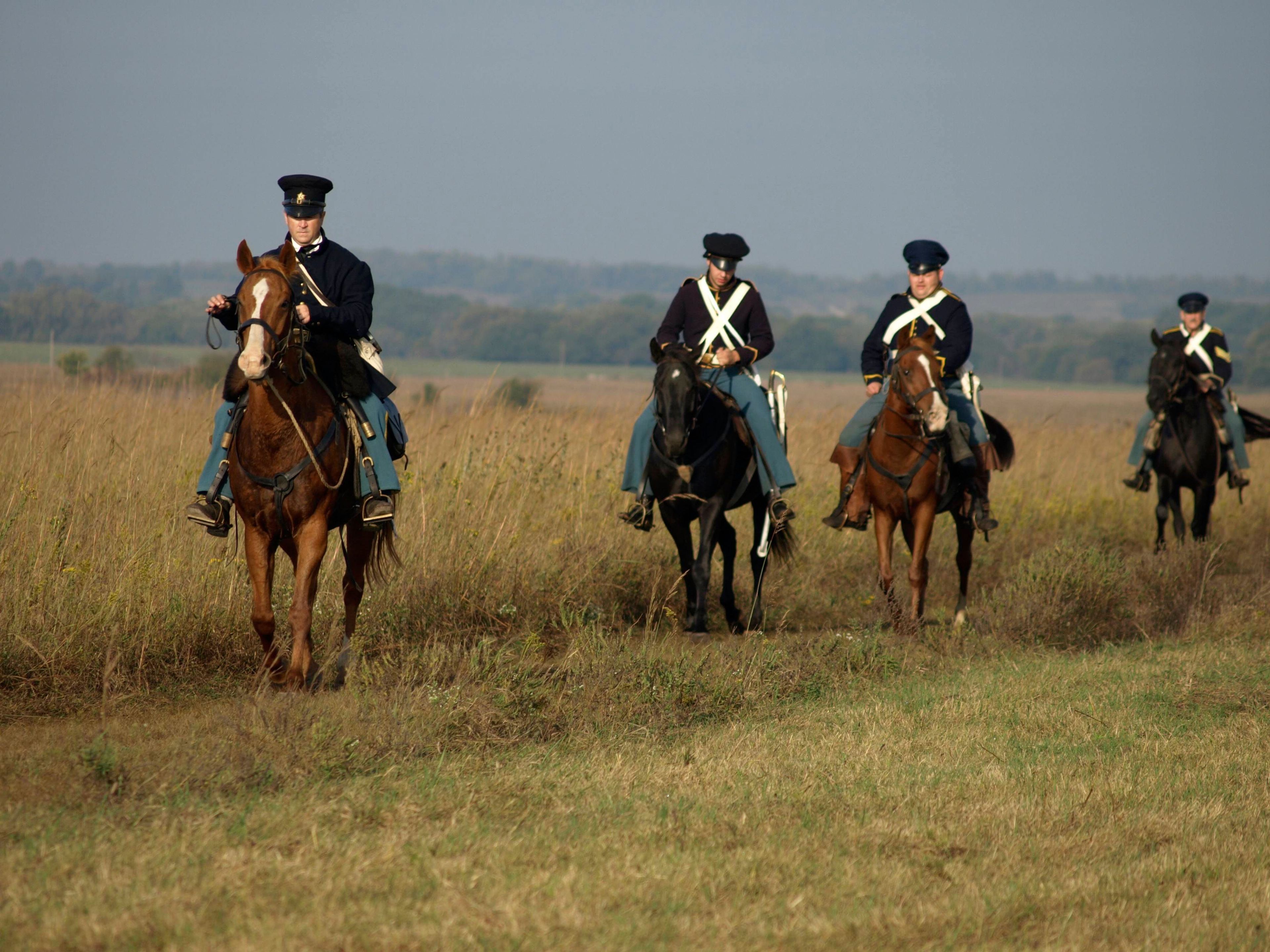 Soldiers on horseback patrolling the prairie