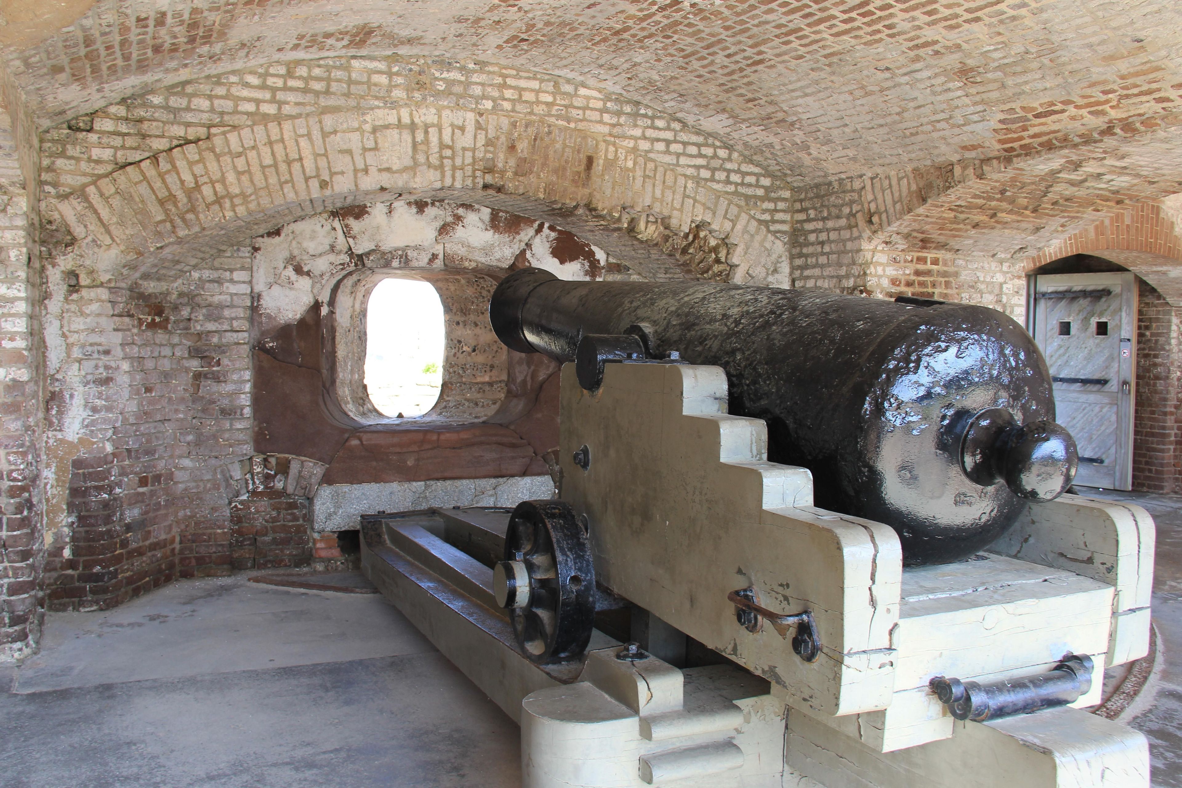 Fort Sumter cannon sitting on cannon carriage under a brick casemate