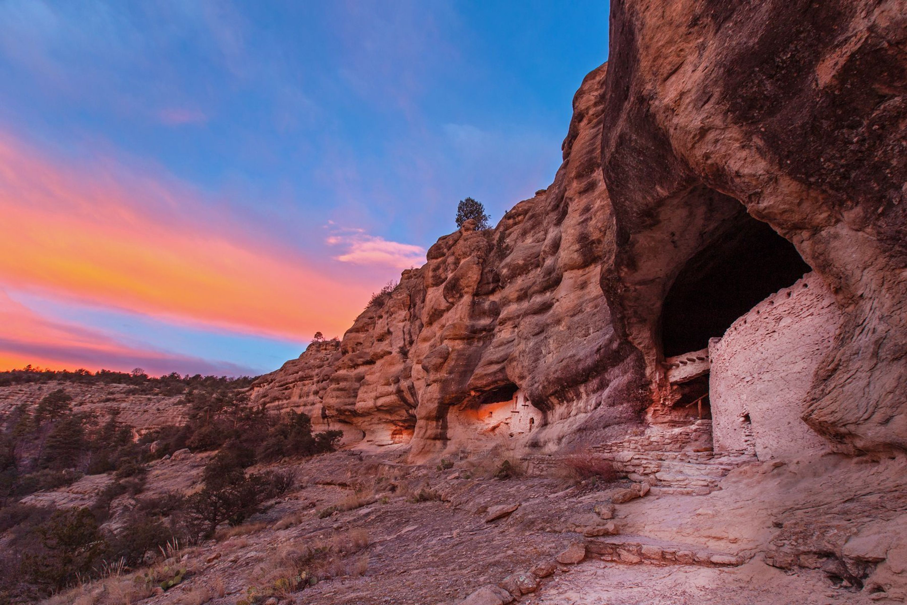 Visitors enjoy panoramic views of the canyon and dwellings at Gila Cliff Dwellings.