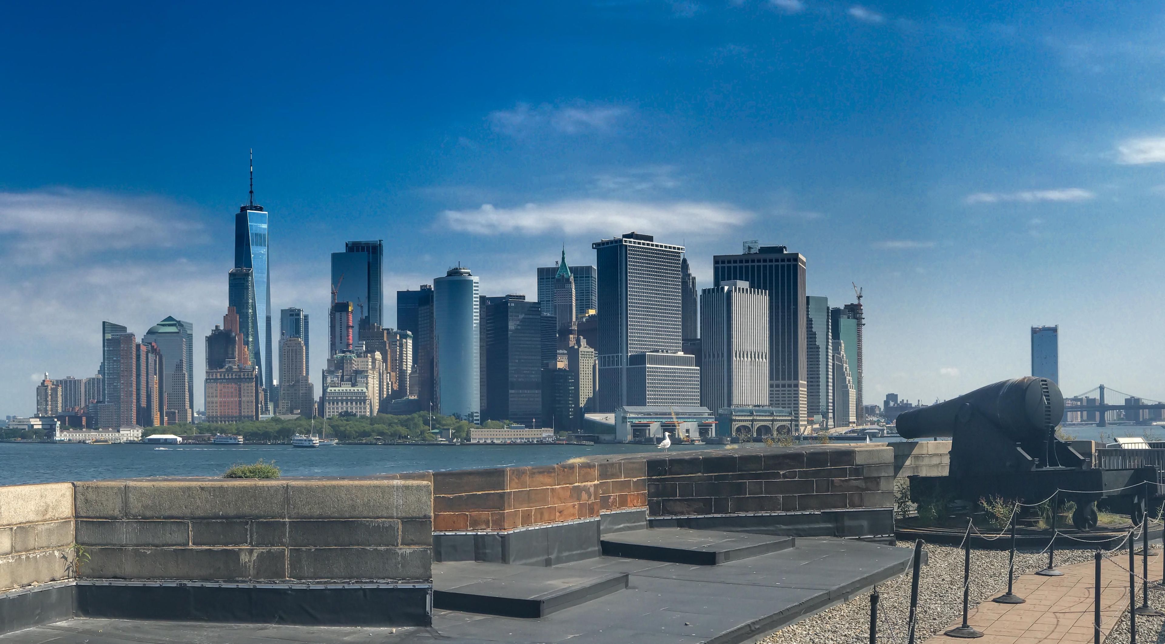 A civil war era canon sitting upon the top of Castle Williams juxtaposes the new and old, with the glimering shine of Manhattan in the background