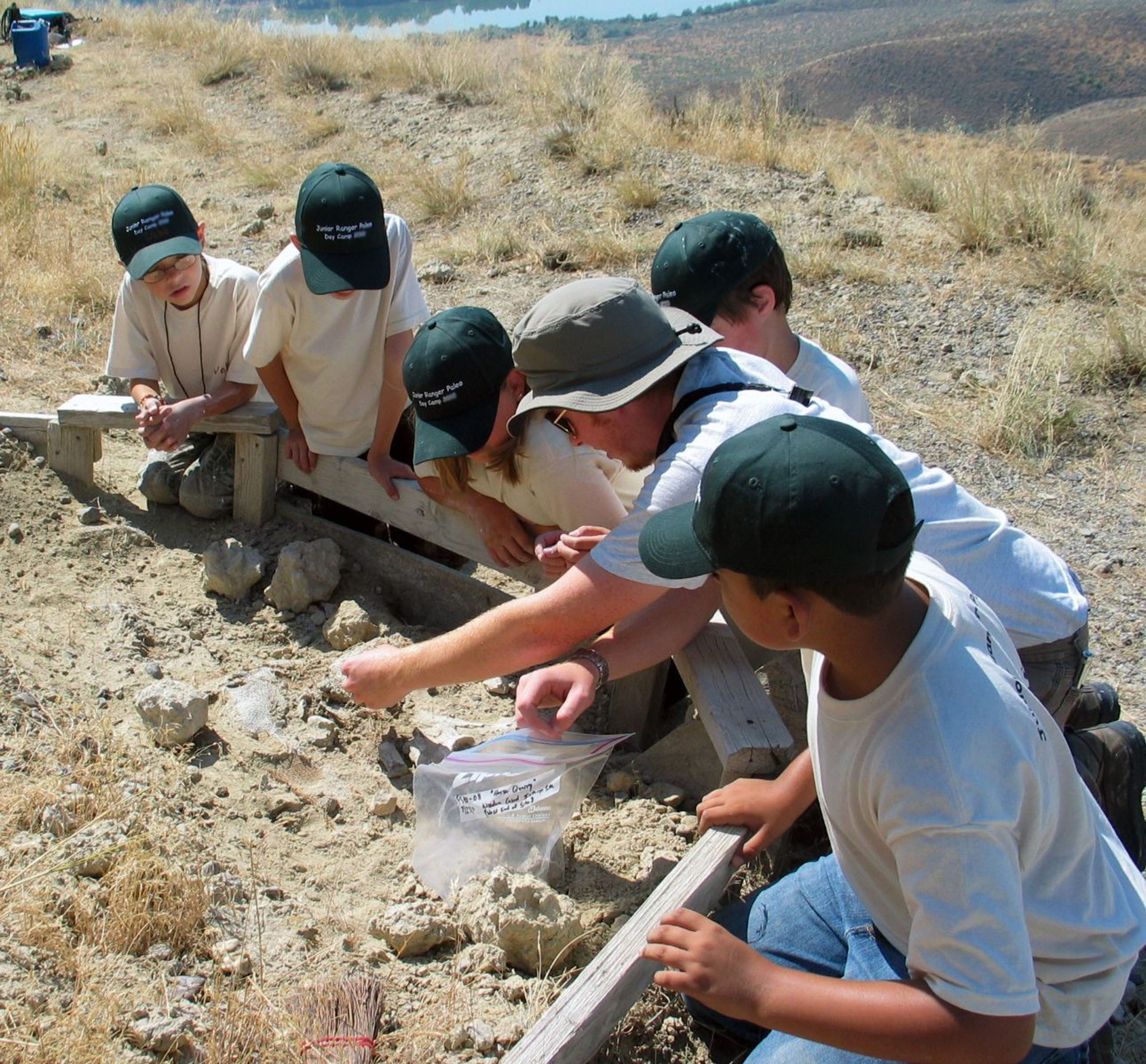 Jr. Rangers learn about paleontology at a fossil site.