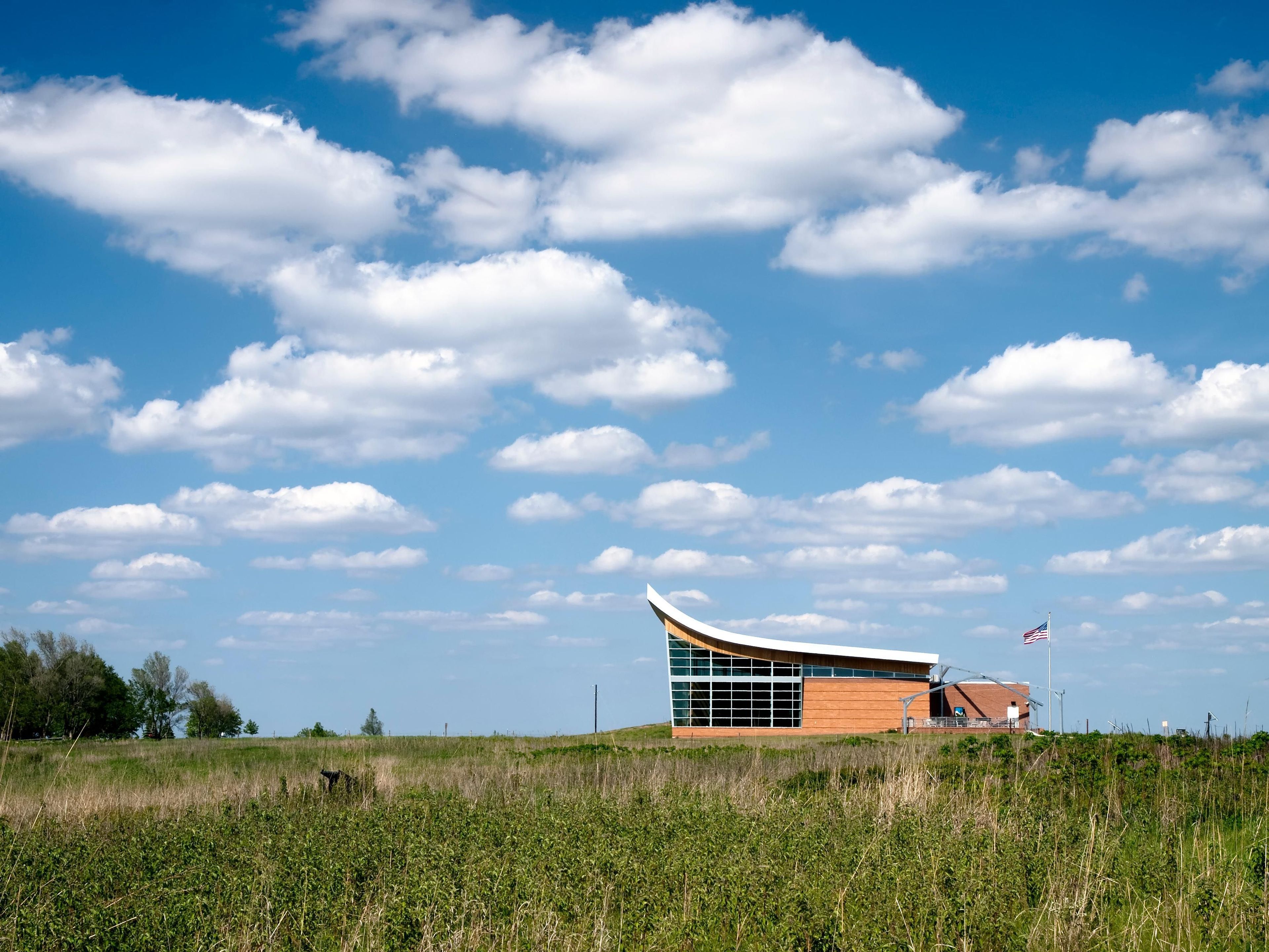 Thousands of visitors stop to view the oldest restored tallgrass prairie in the National Park Service from the Heritage Center back patio.