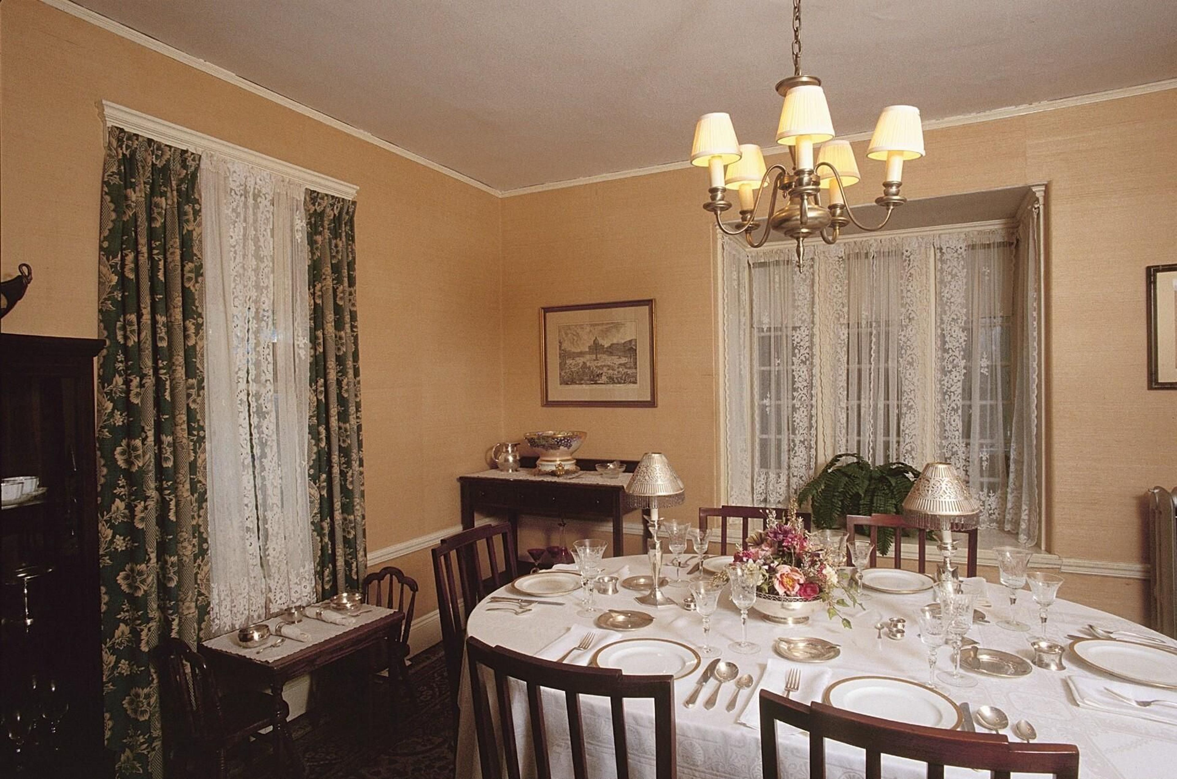 The dining table is set with the fine china and silver that Rose Kennedy received as a wedding present.