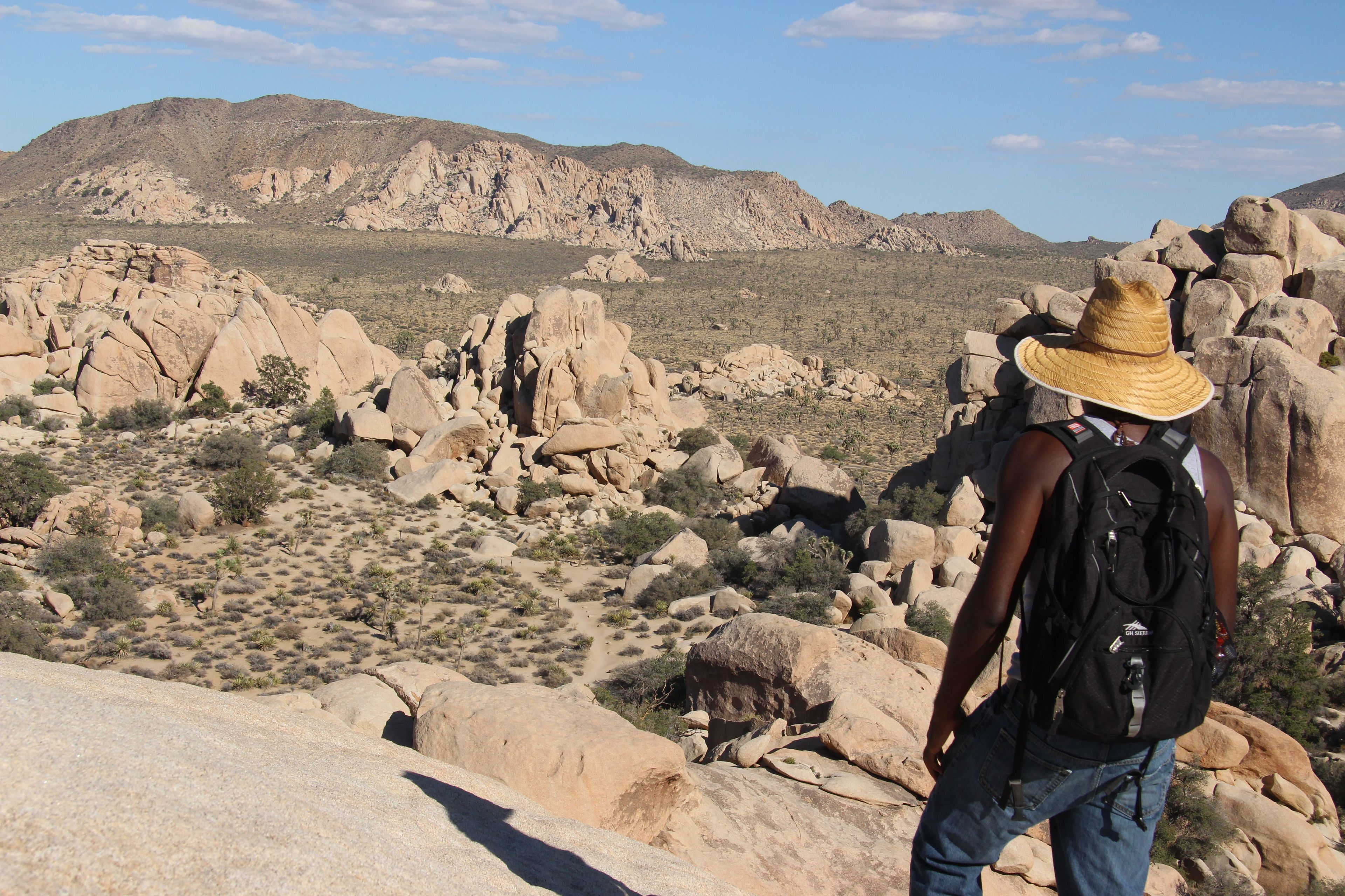 Scrambling to the top of boulders in Joshua Tree can get you a great view.