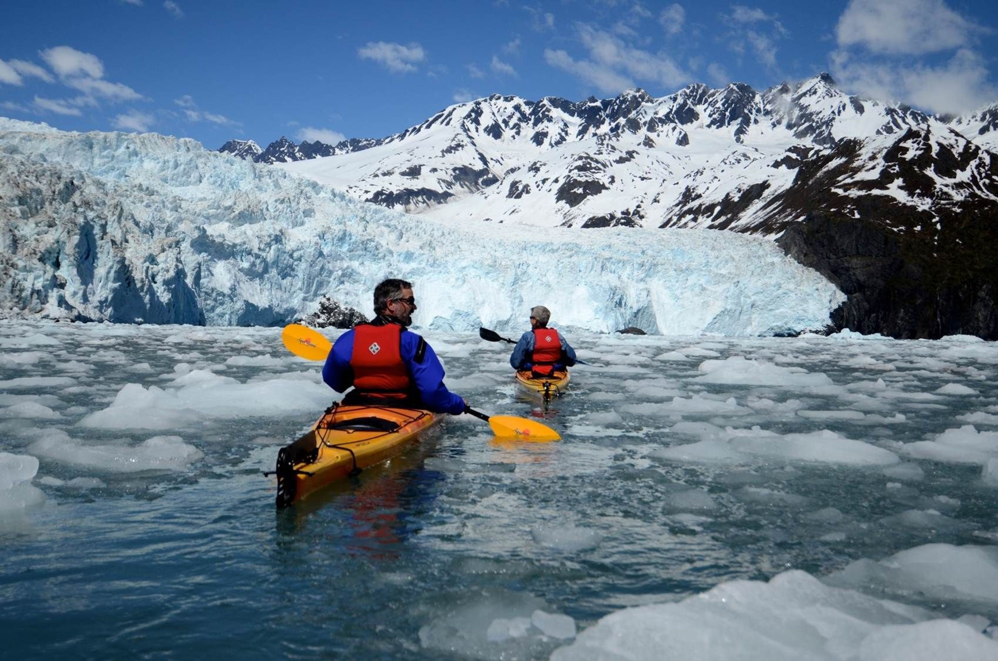 Kayakers enjoy the spectacular scenery in the fjords in Aialik Bay.