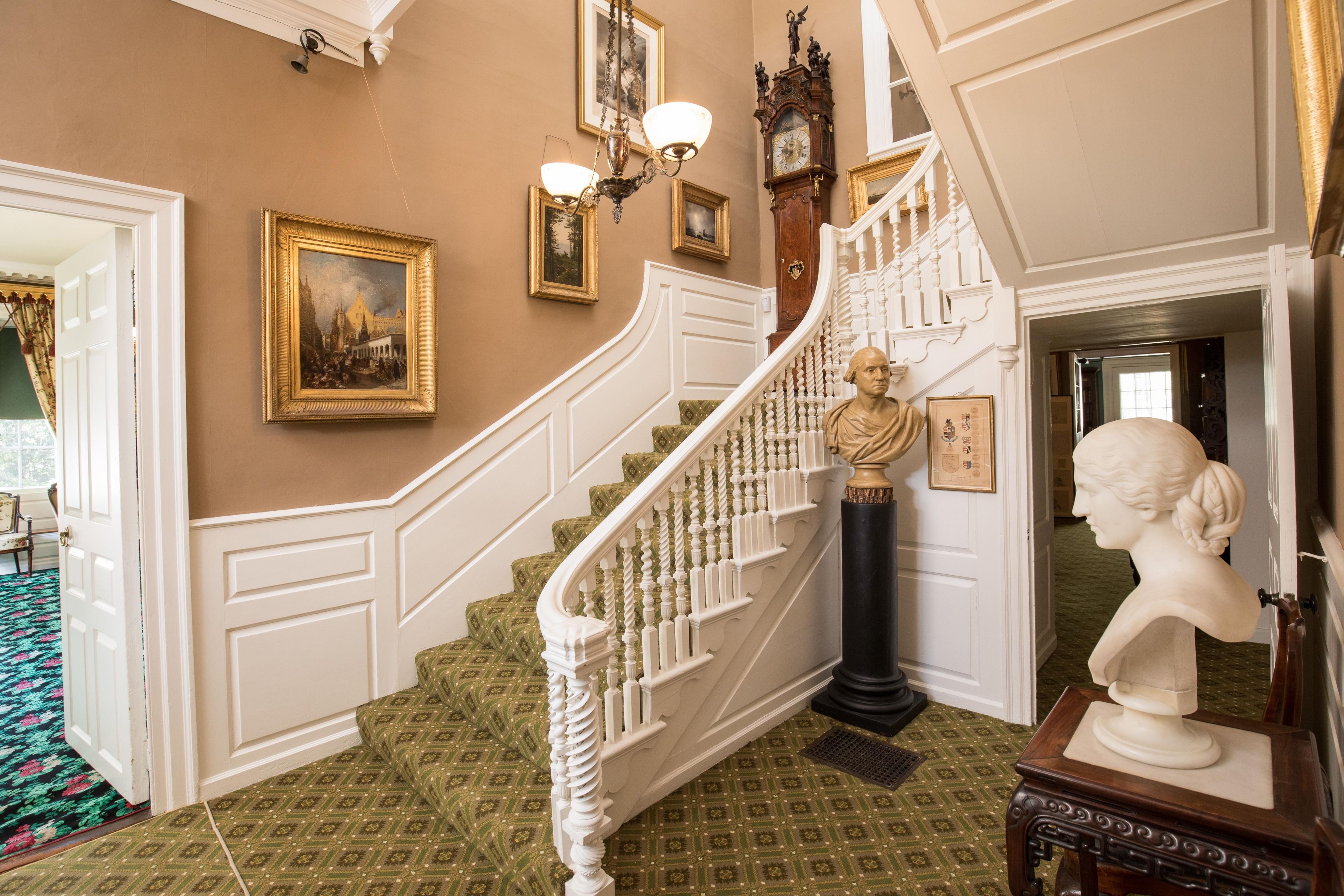 The Longfellows' iconic front entry features a bust of Washington at the turn of the stairs