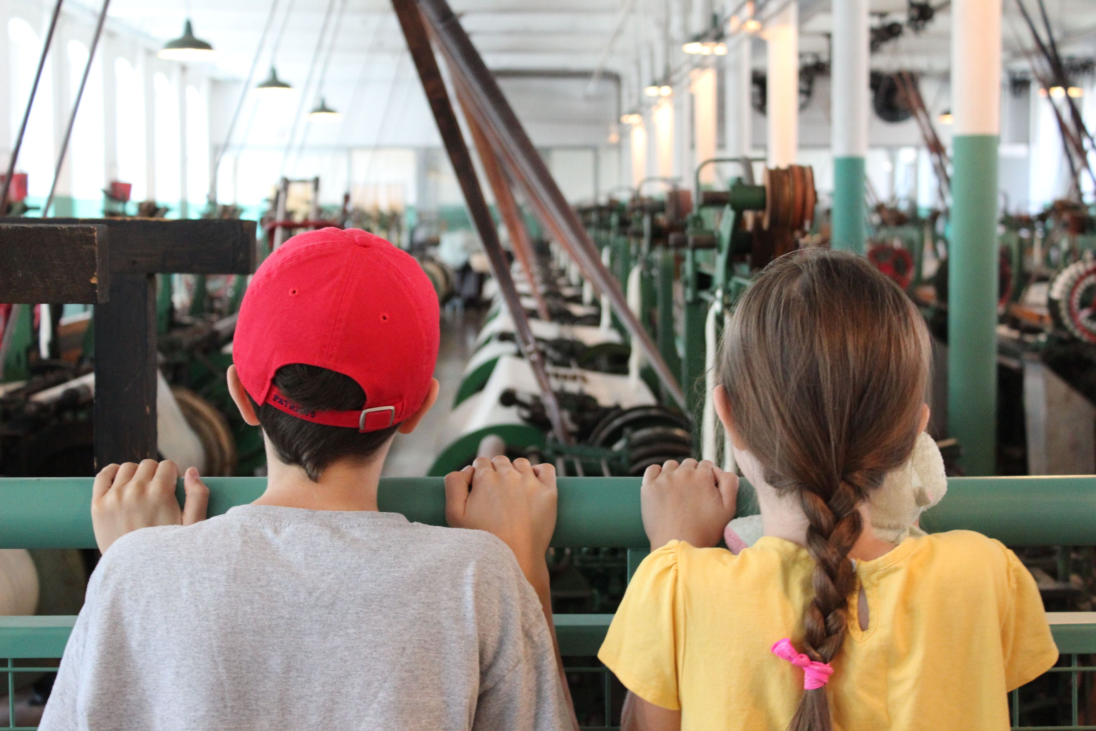 The working weave room at the Boott Cotton Mills Museum surrounds you with the sights and sounds of a turn-of-the-century working cotton textile factory.