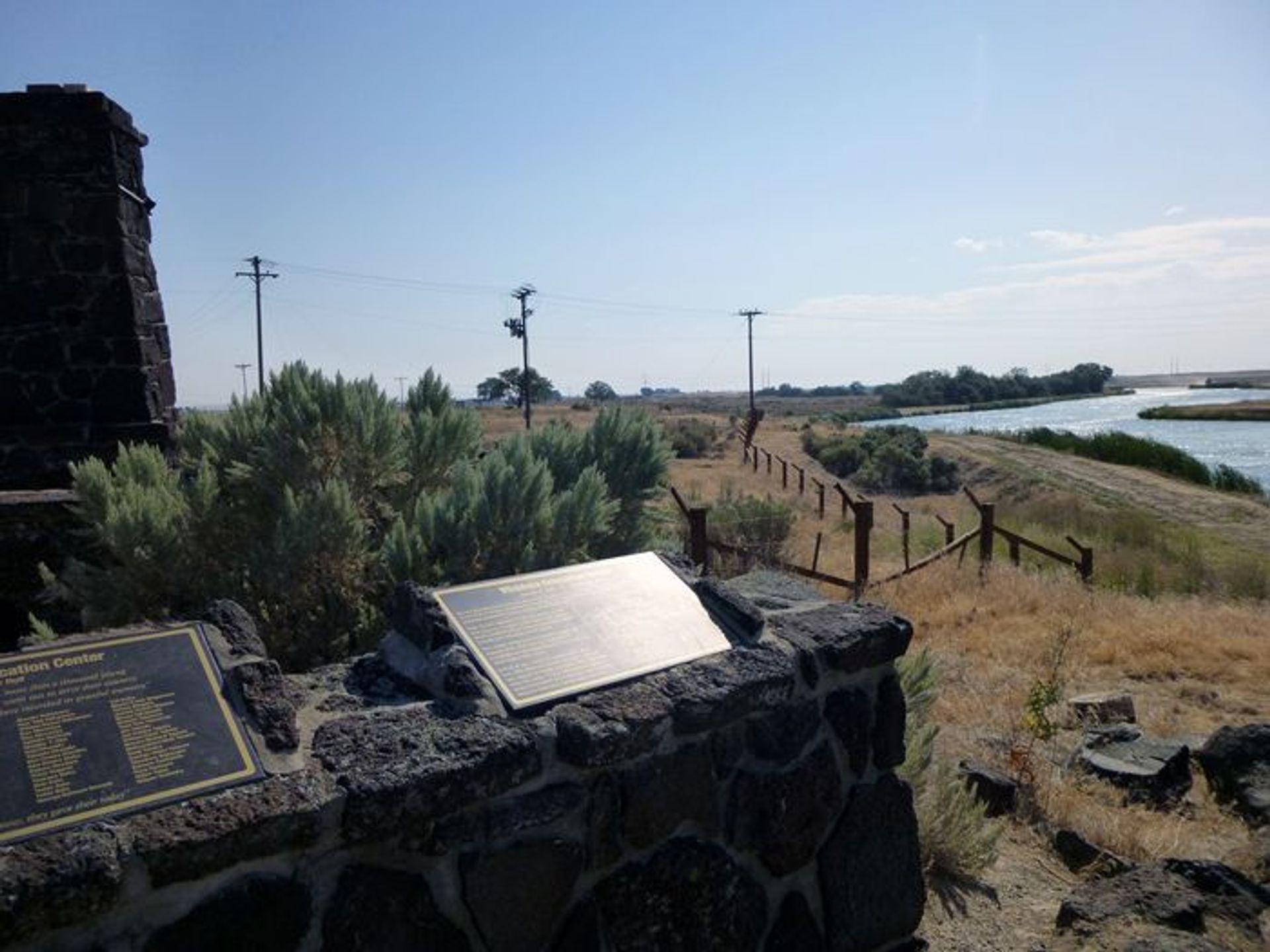 Looking northeast from the entrance area to the Northside Canal and reconstructed barbed wire fence.