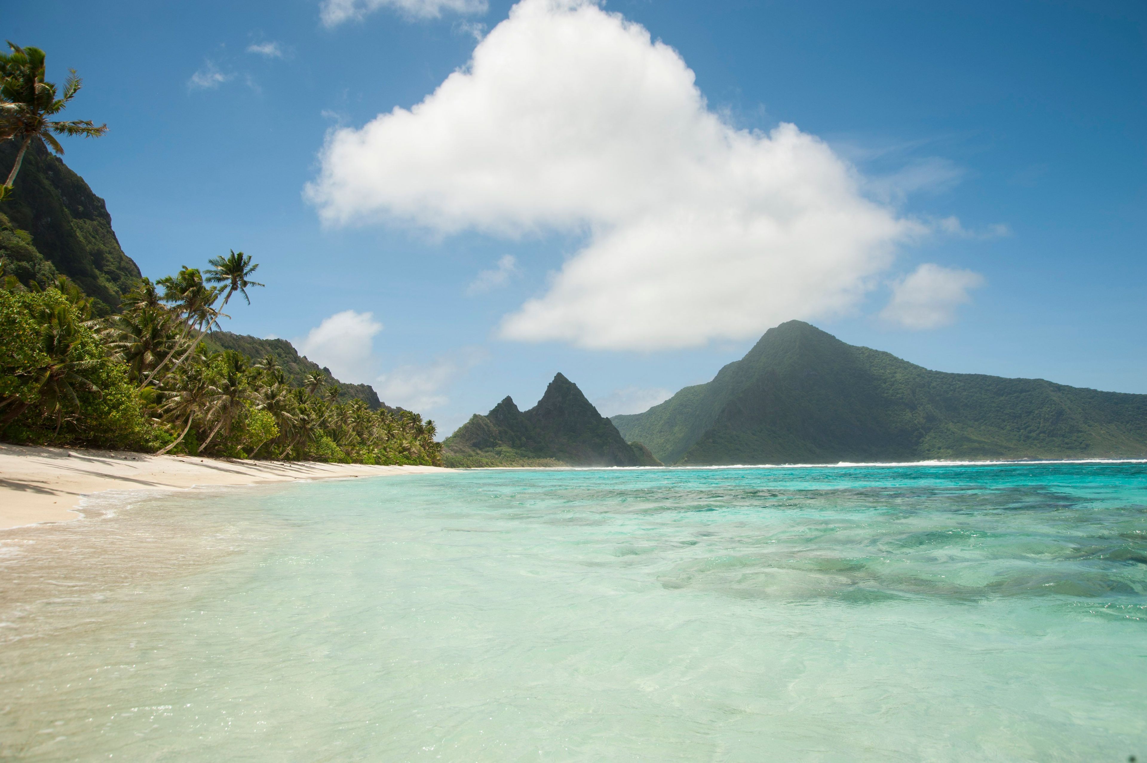 With a secluded sandy beach and fringing reef, Ofu unit of the park is an ideal place to snorkel or simply enjoy the solitude. The island of Olosega rises in the distance.