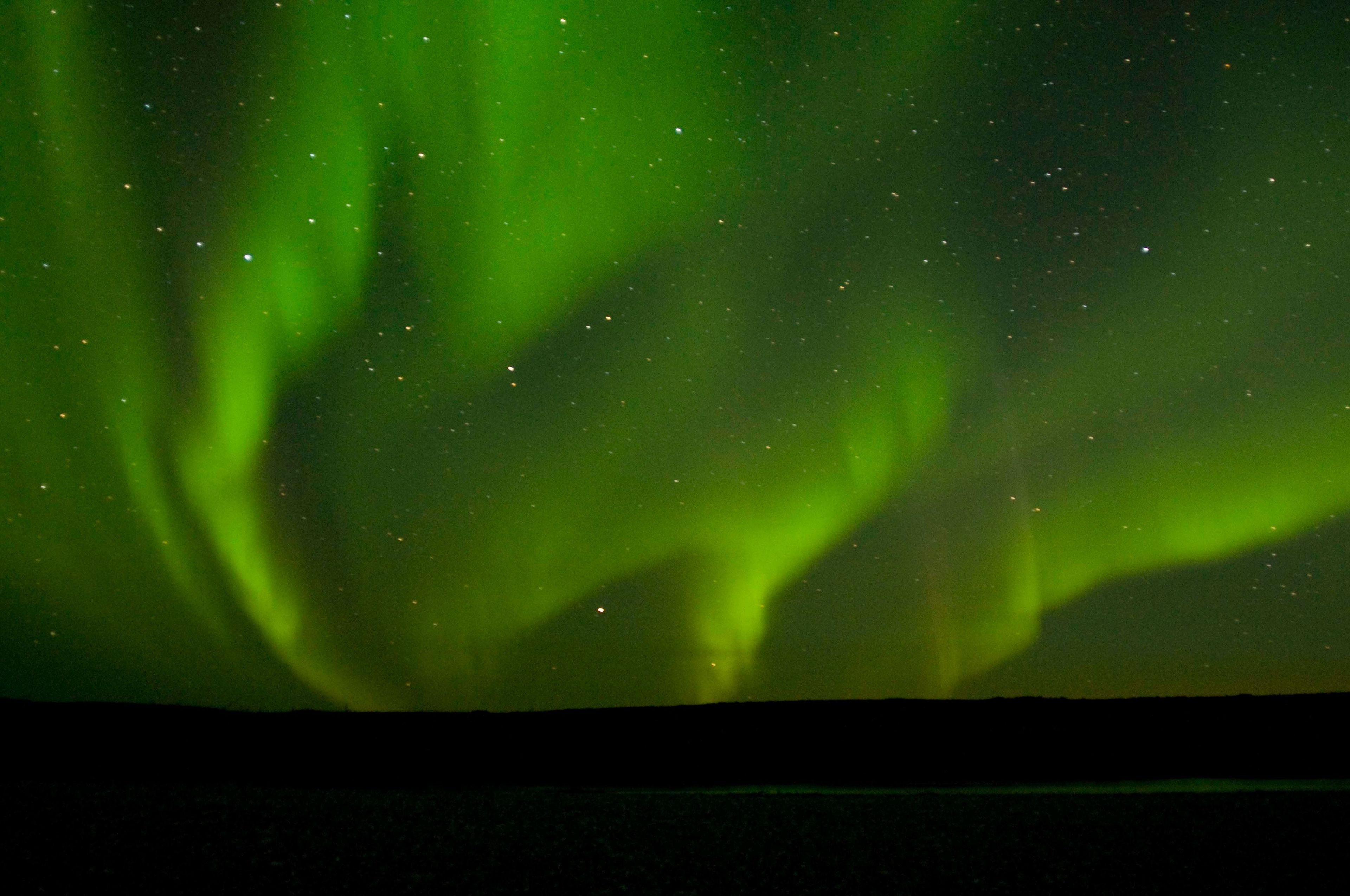 A huge spray of northern lights is reflected in a tiny sliver of water in the Noatak River. This image was captured in early September at 2:30 in the morning.