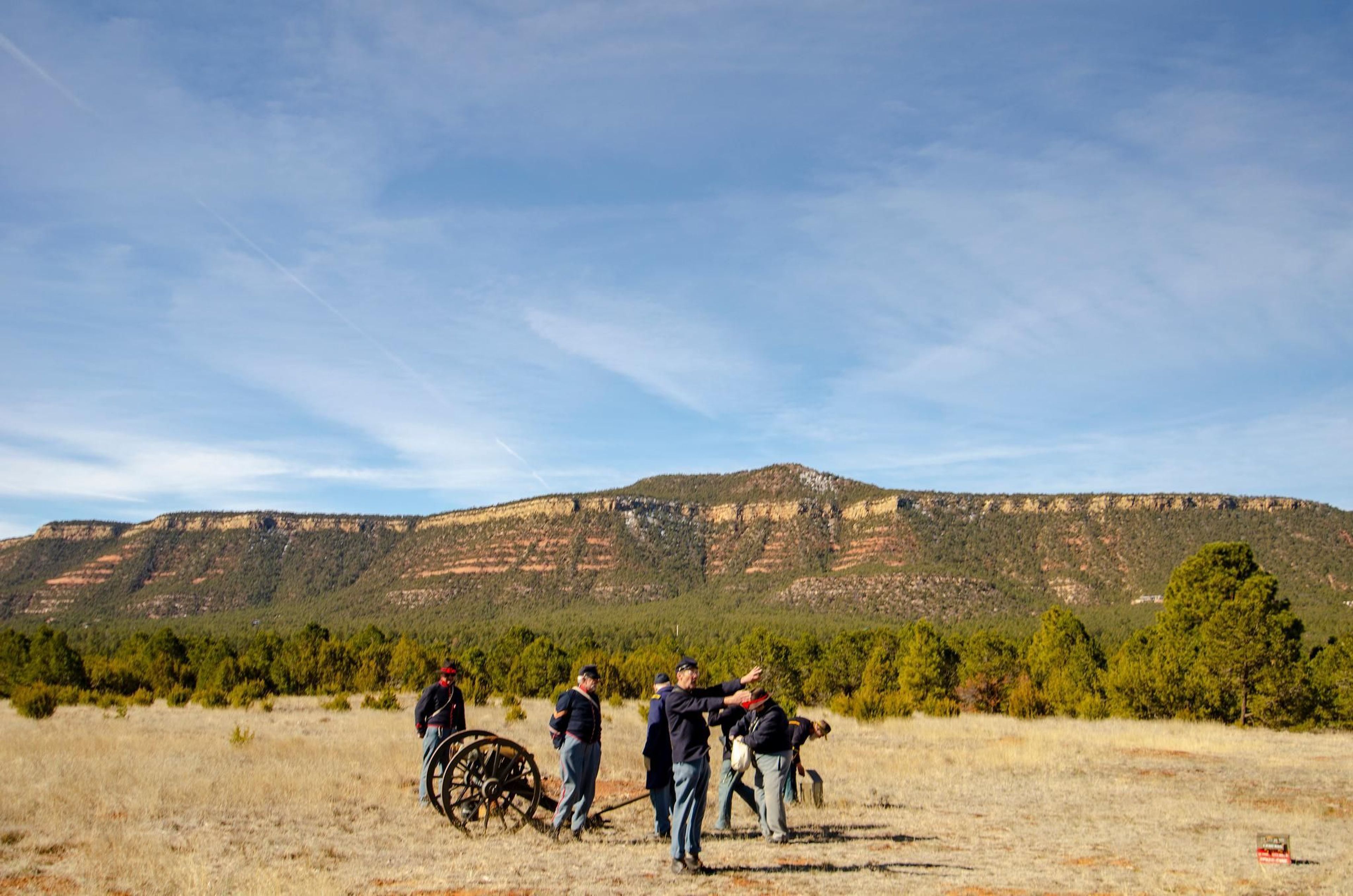 Civil War Encampment reenactors ready a black powder cannon demonstration in front of Glorieta Mesa,