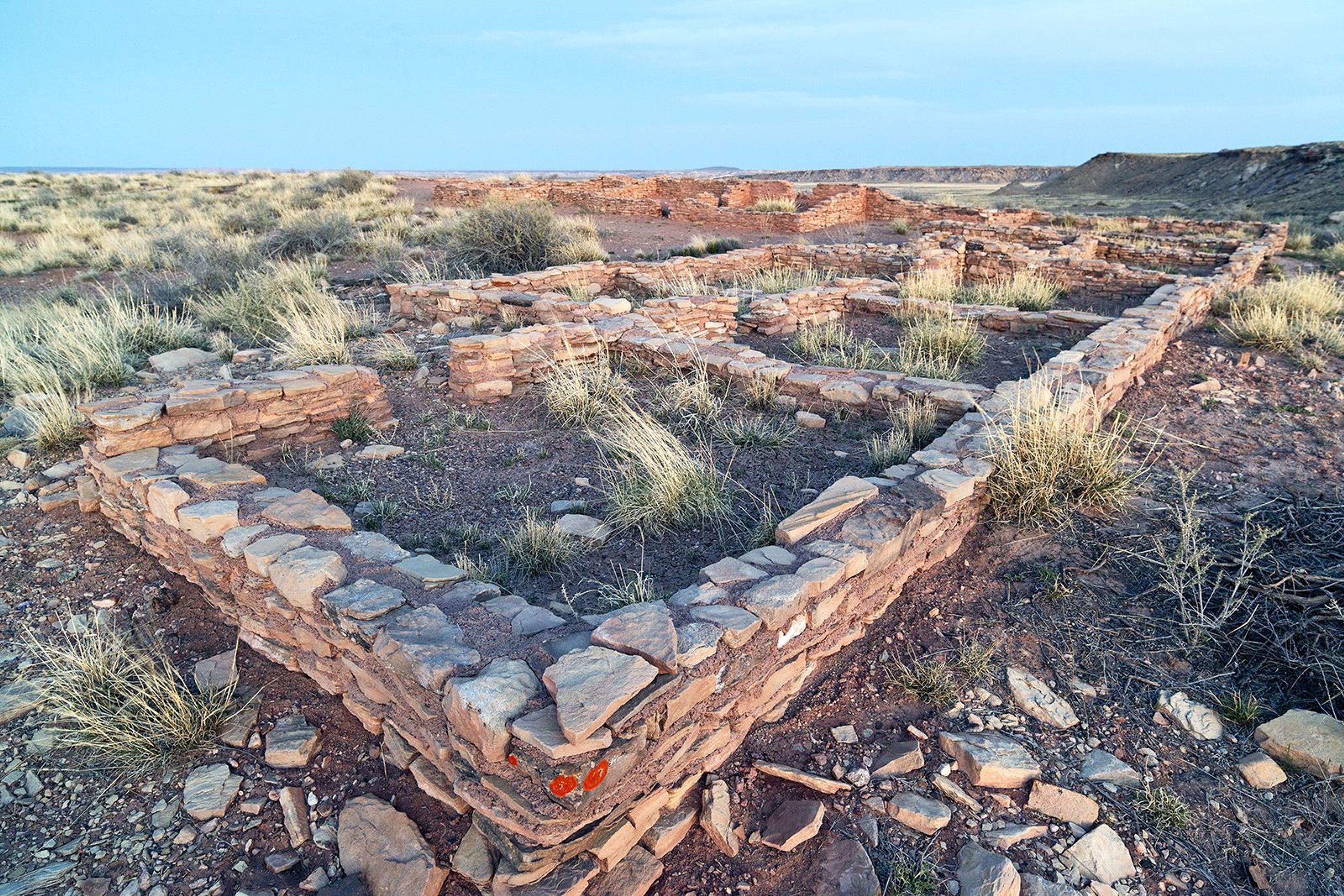 Masonry wall remnants are all that are left of a hundred room pueblo.