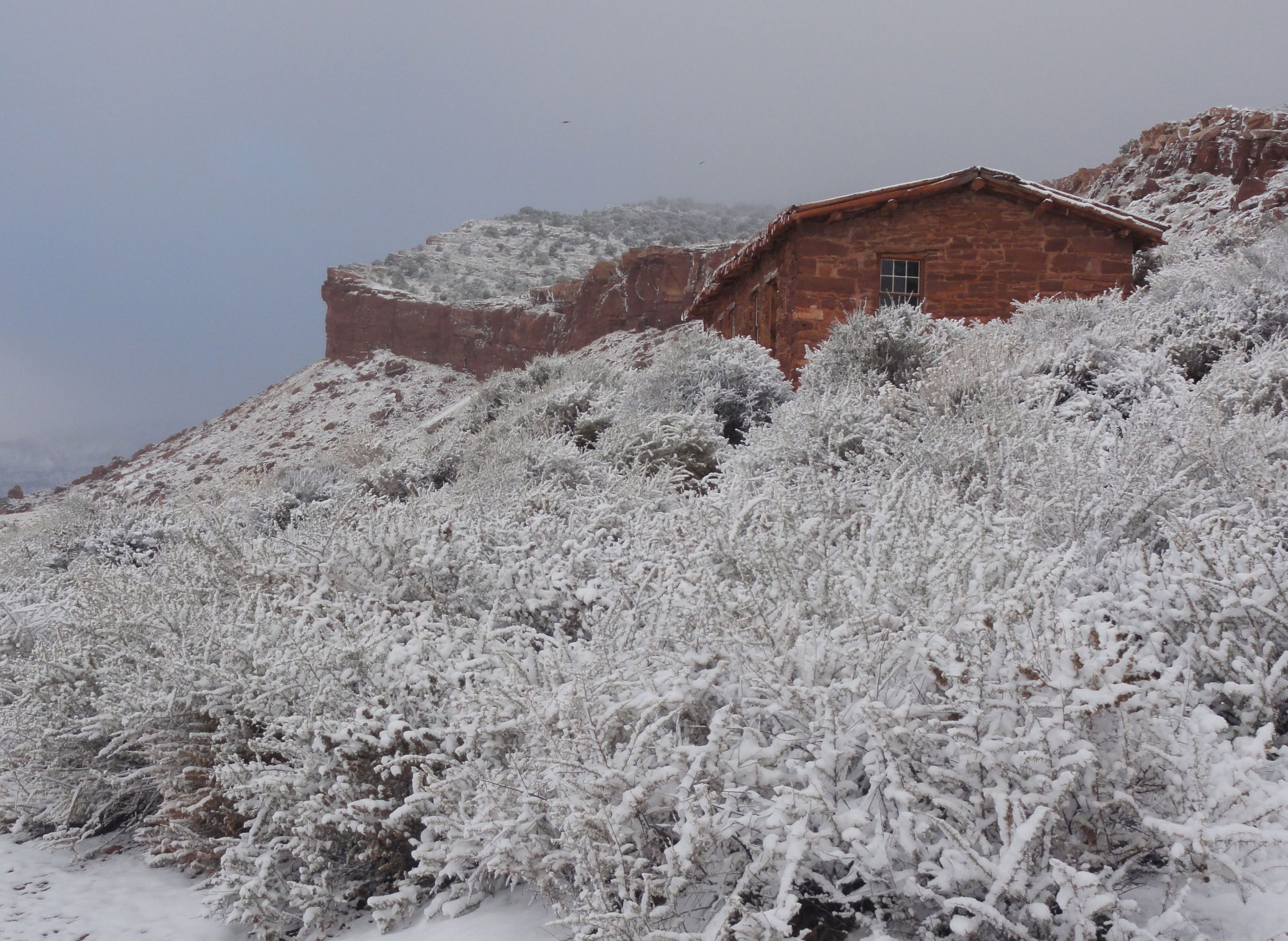 Wintertime showcases a stark peace and stillness at the historic buildings. Pictured here, West Cabin sticks out after a snowstorm.