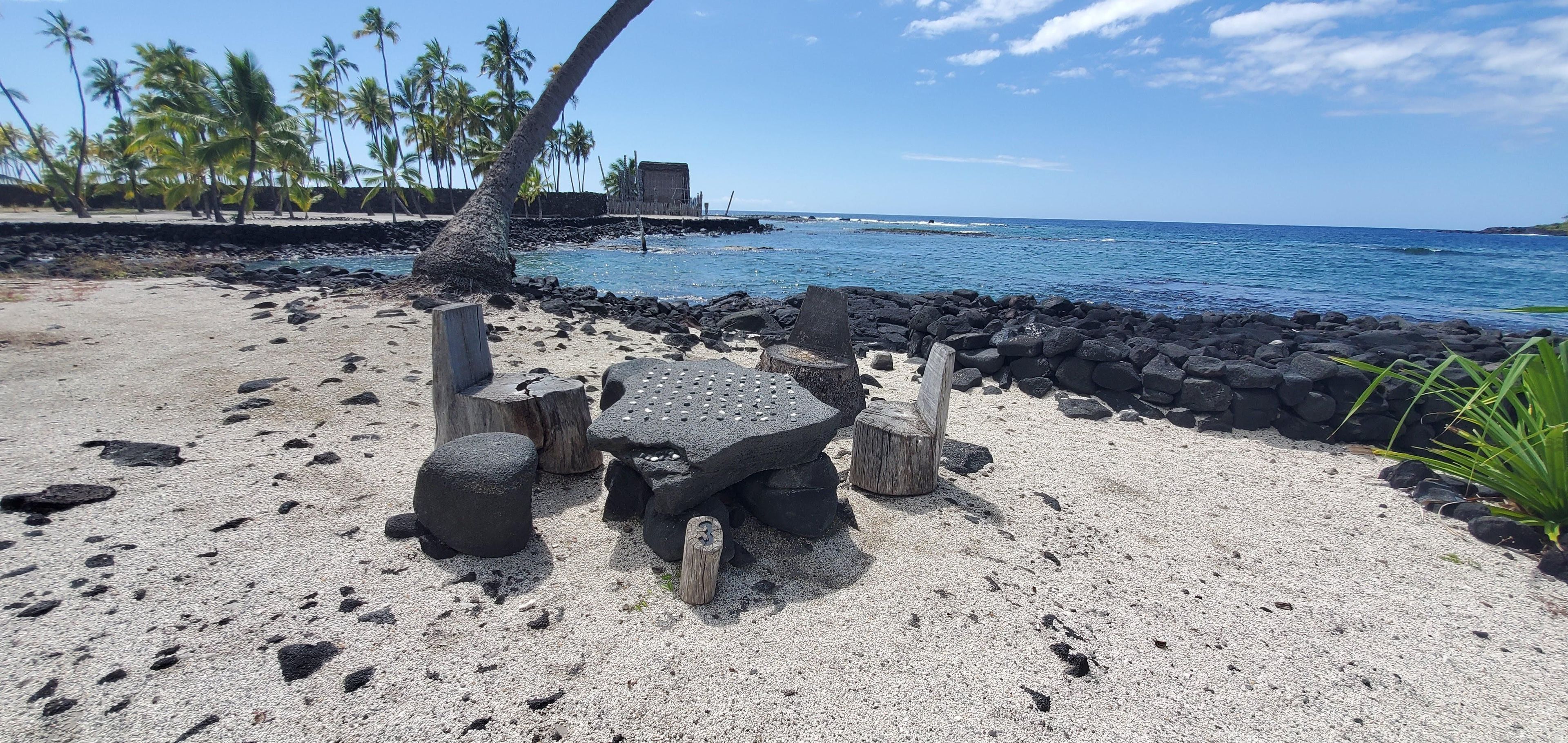 Explore the picturesque Royal Grounds and catch a game of Kōnane on the shores of Hōnaunau Bay.