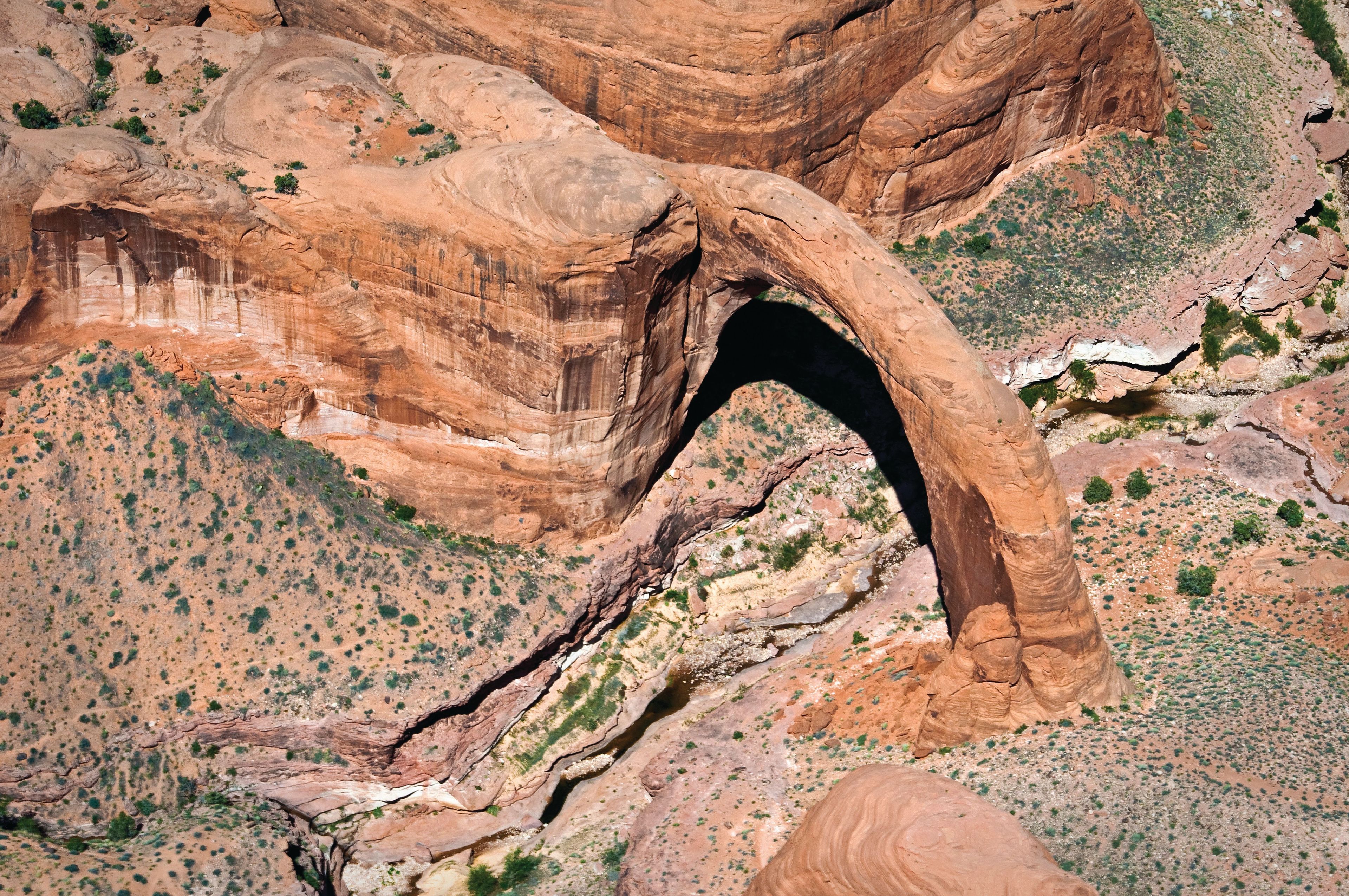 Seen from the air, Rainbow Bridge is a graceful curve over the dry stream bed.