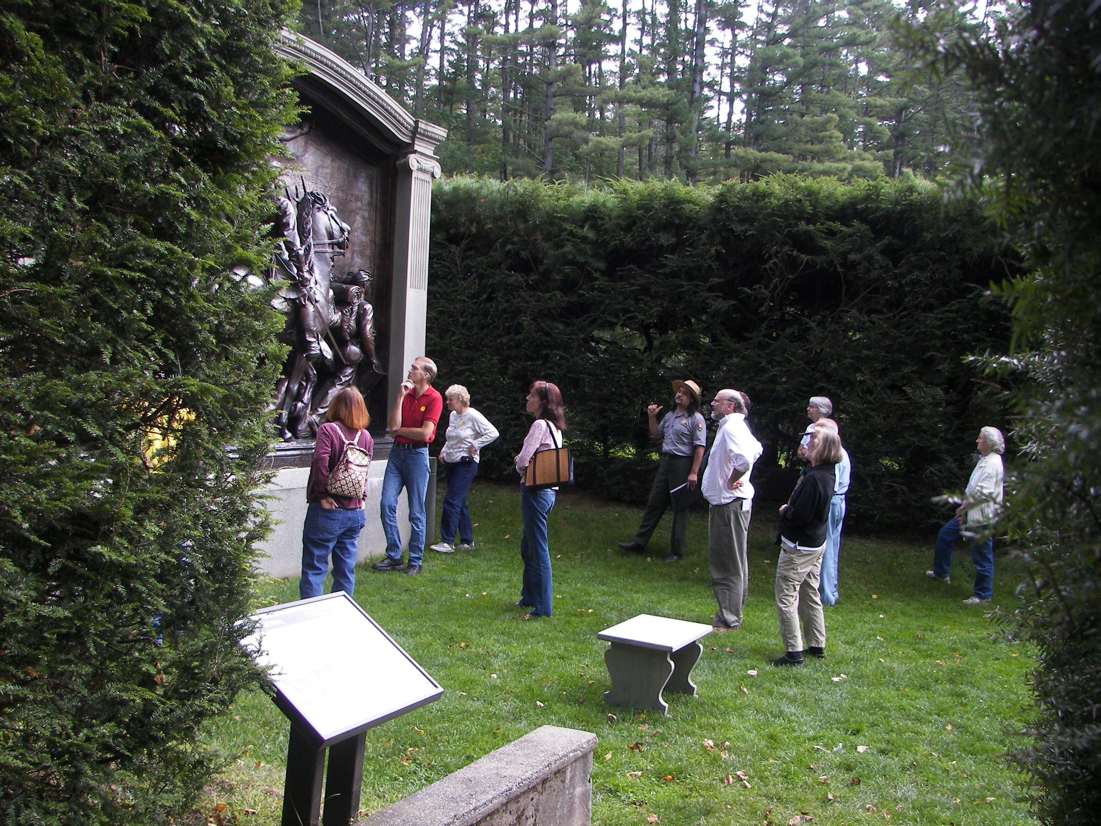 Visitors looking at the bronze cast of the Shaw Memorial, Saint-Gaudens' masterpiece.