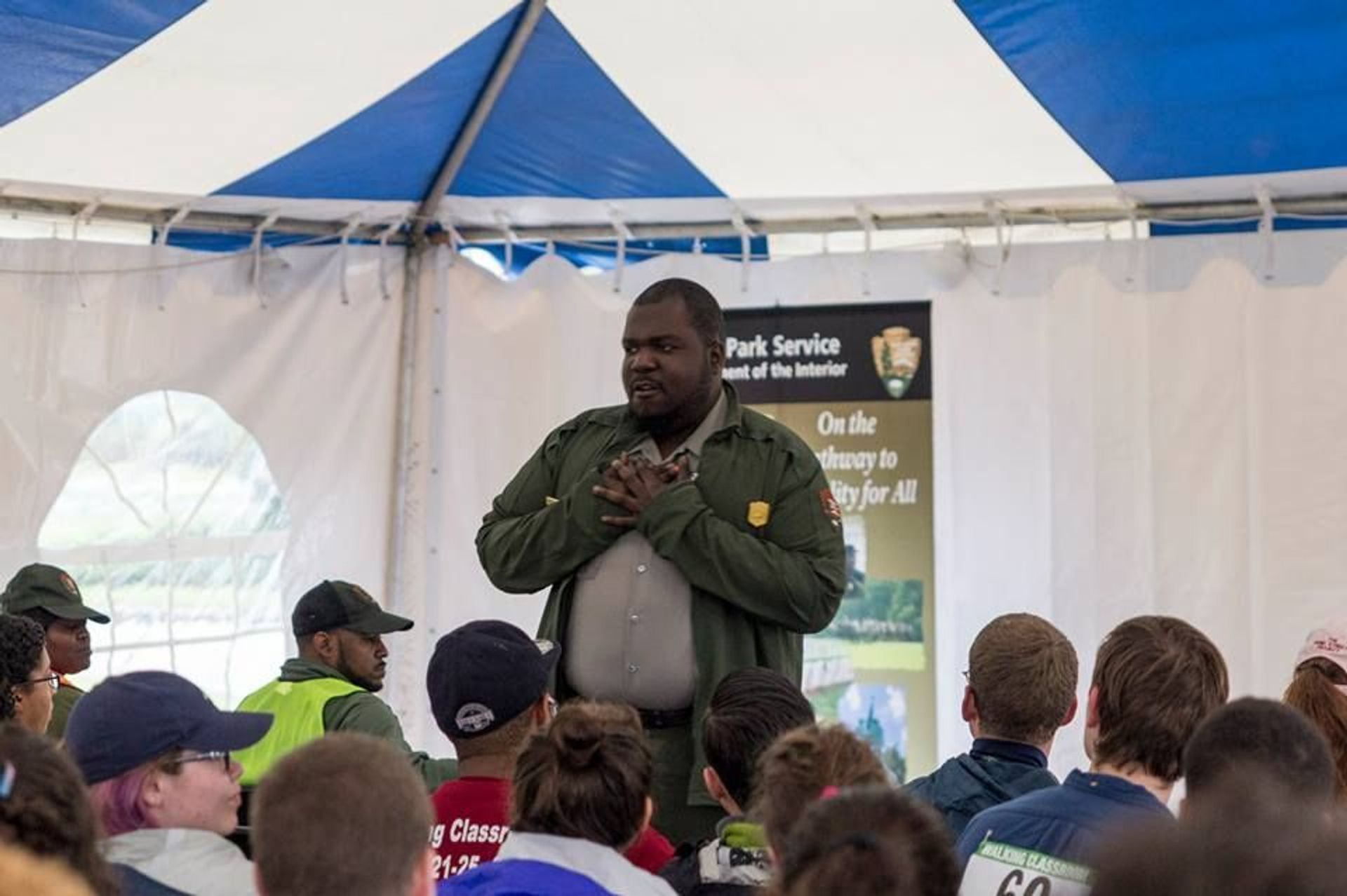 Hundreds of visitors take a moment to listen a Park Ranger speak from the heart.