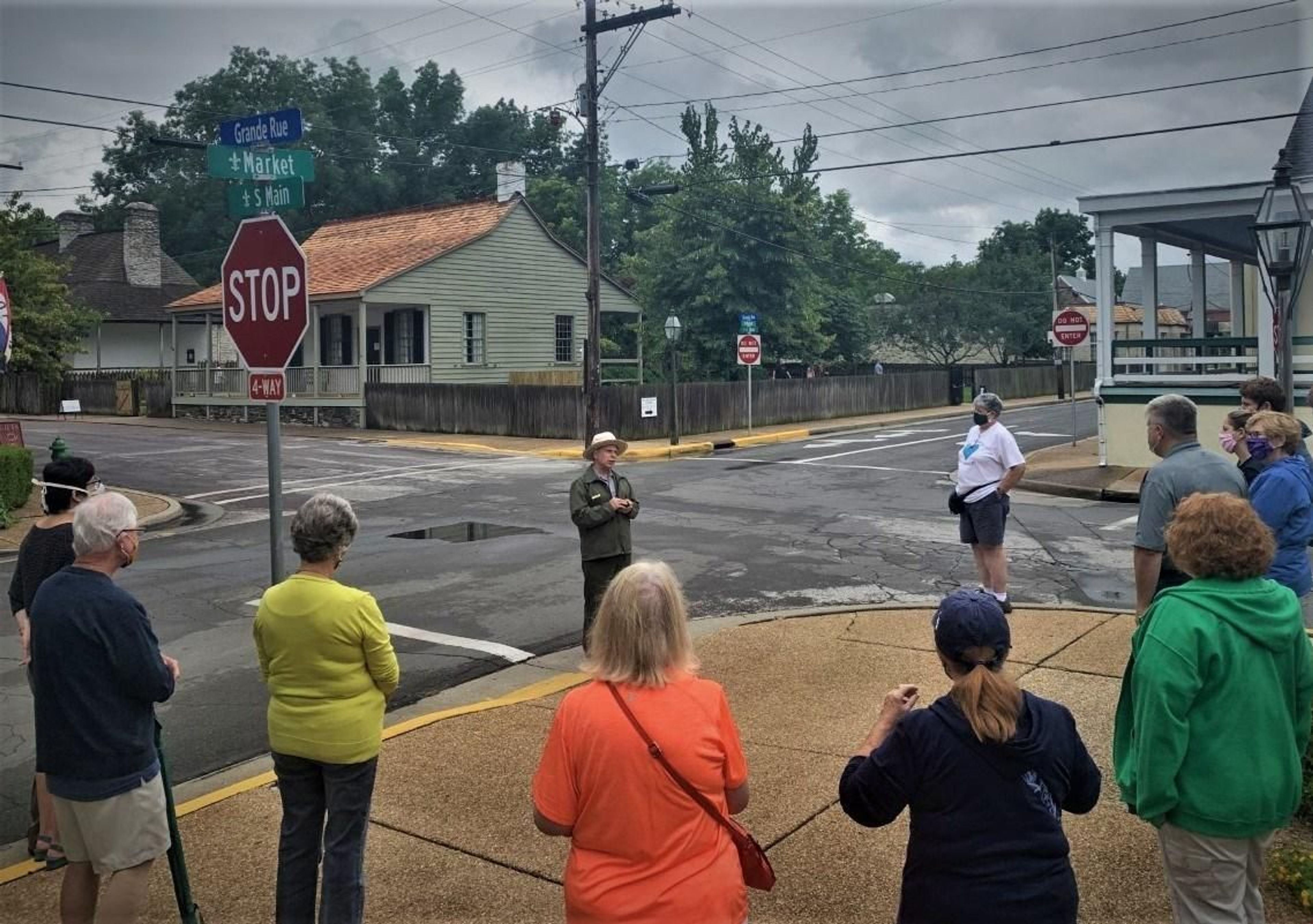 Ranger Rob Lippert leads a program to a group on the corner of Market and Main Street. Across the street is the the Bolduc-LeMeilleur house and Jean Baptiste Valle house.