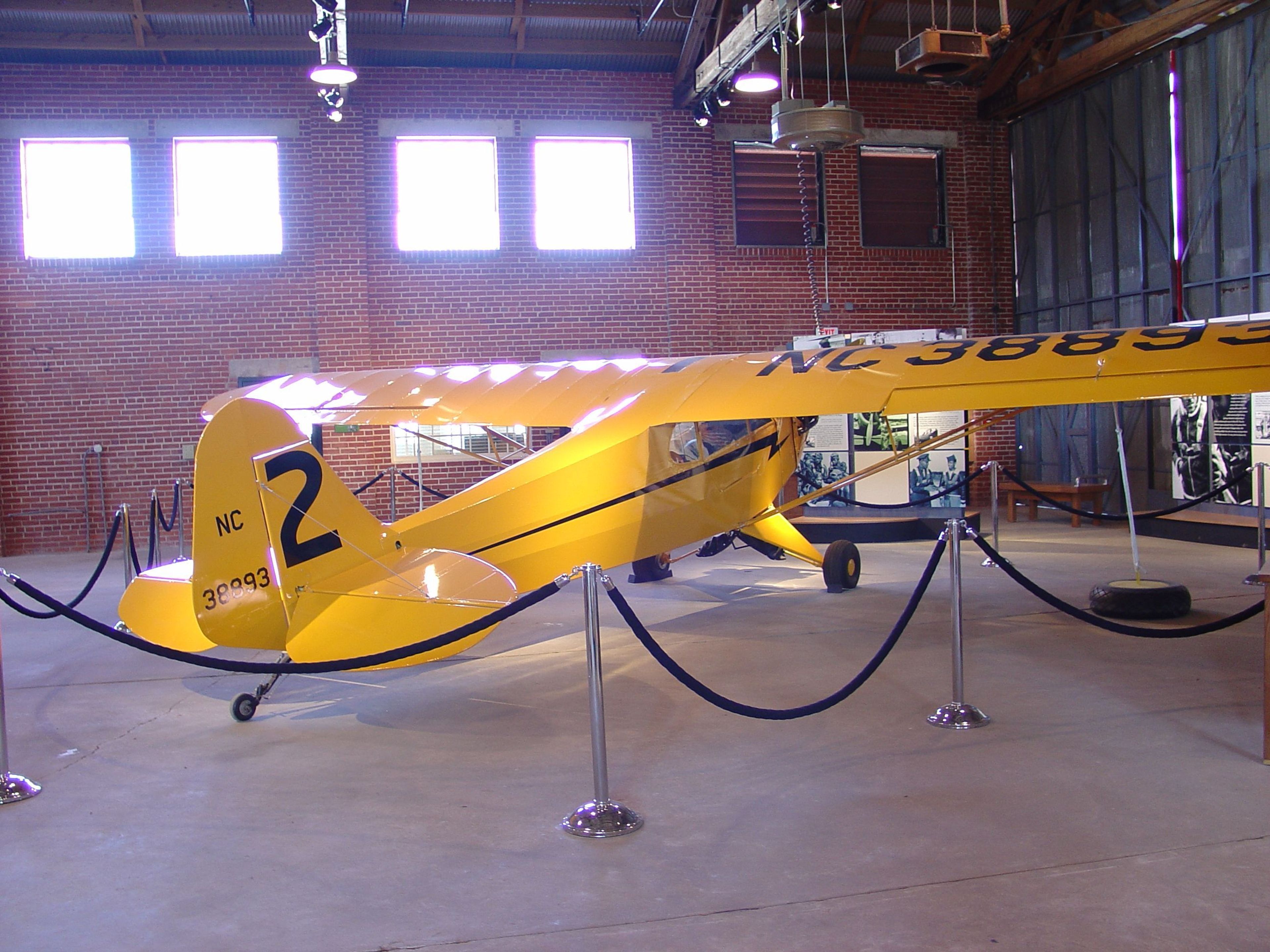 Visitors are surprised to see the small size of the airplane in which First Lady Eleanor Roosevelt took a flight with Negro Pilot Charles A. Anderson.