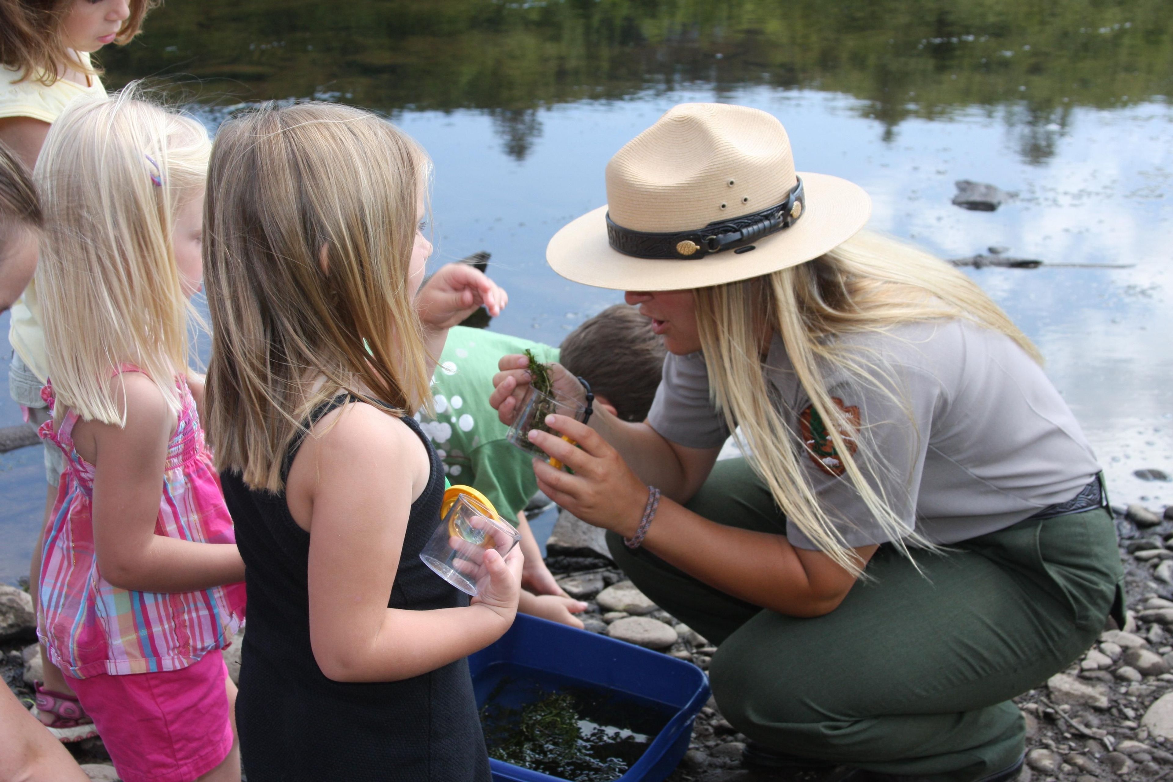 A Park Ranger shows children the wonders of nature