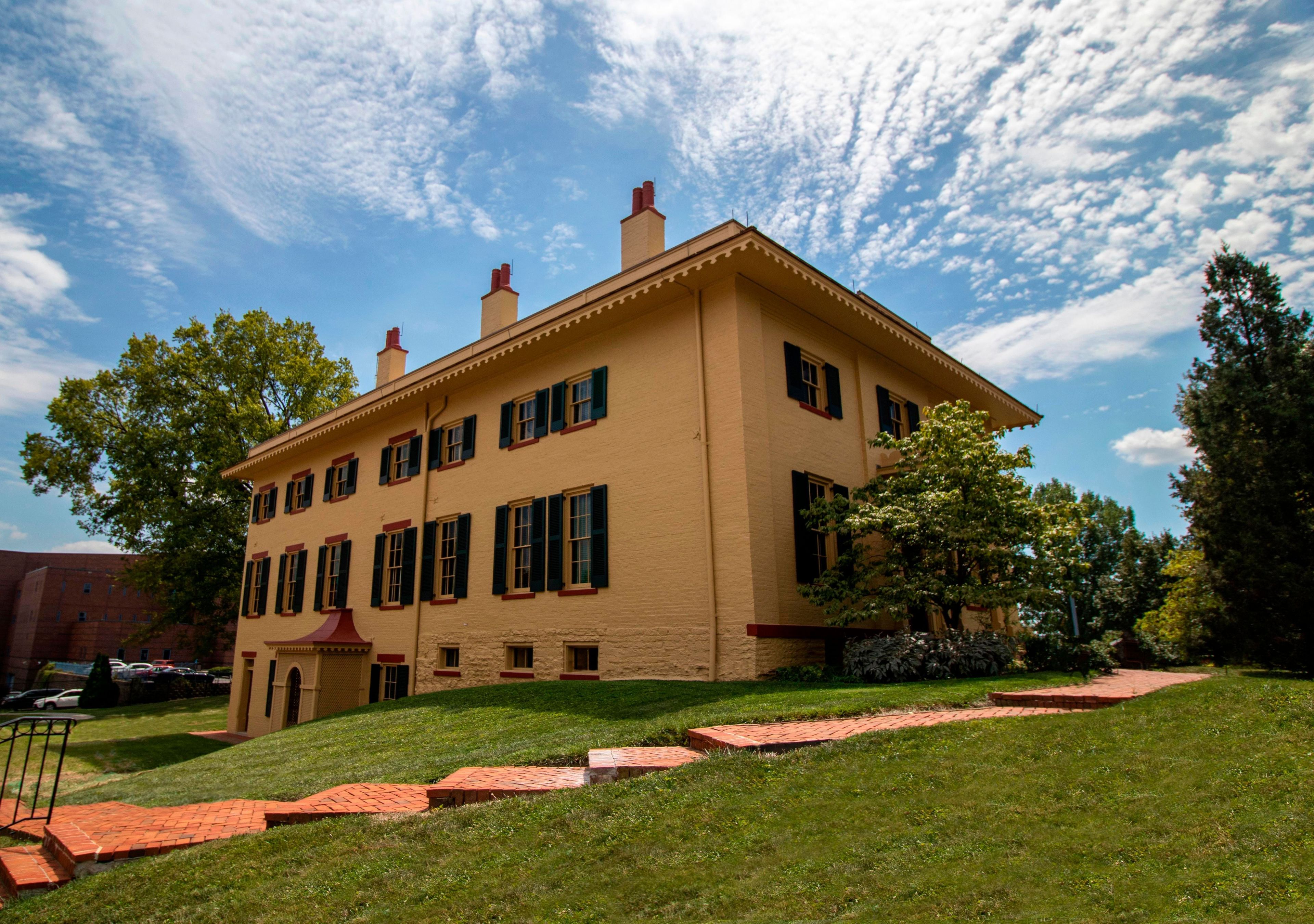 The Taft Family Home showing the lower-level entrance on the side and the main entrance on the front