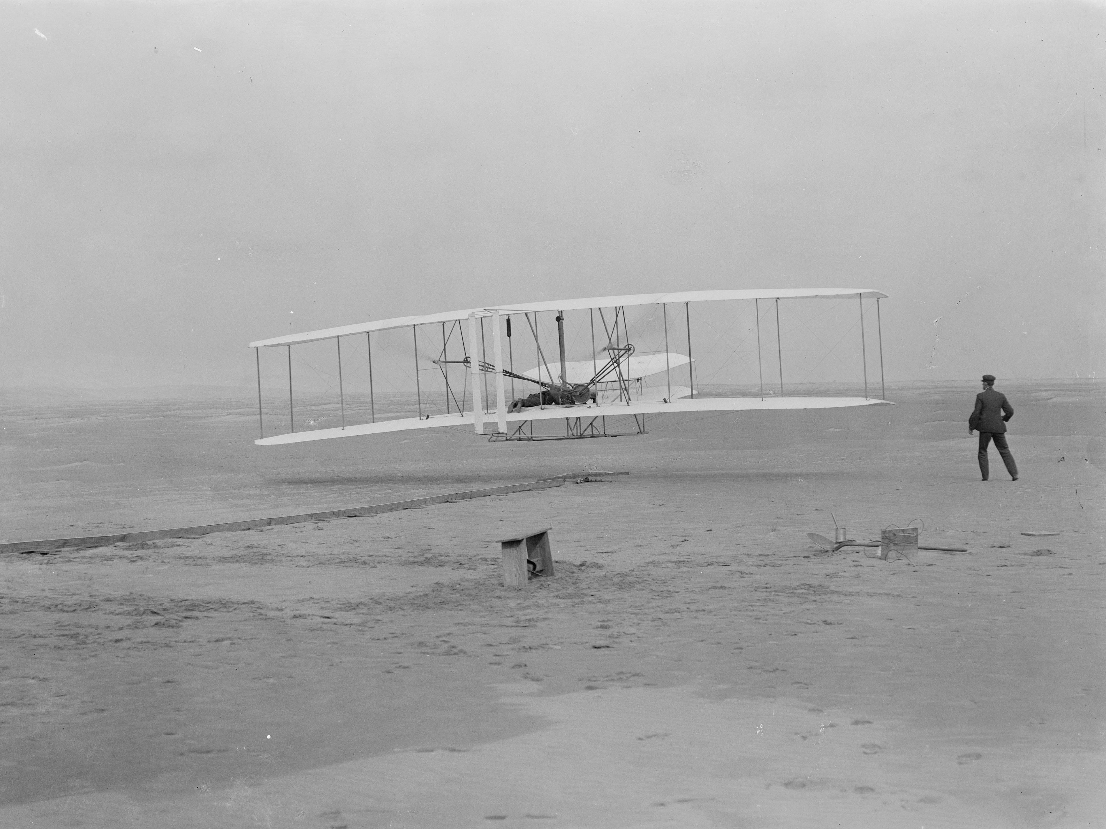 Orville takes to the air in the flyer for the first time on December 17, 1903.