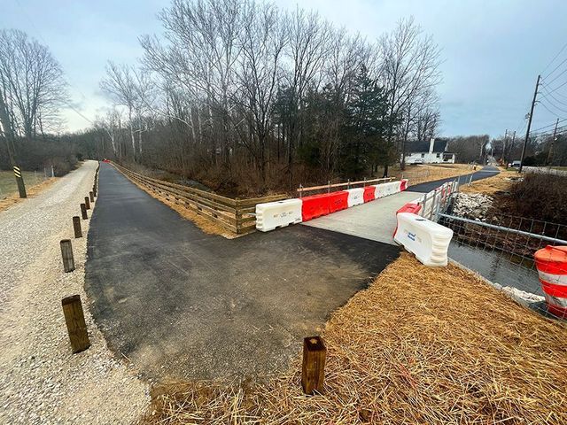 Image of a portion of the new south extension of the Jackson Creek Trail. The gravel driveway along the trail is a private drive